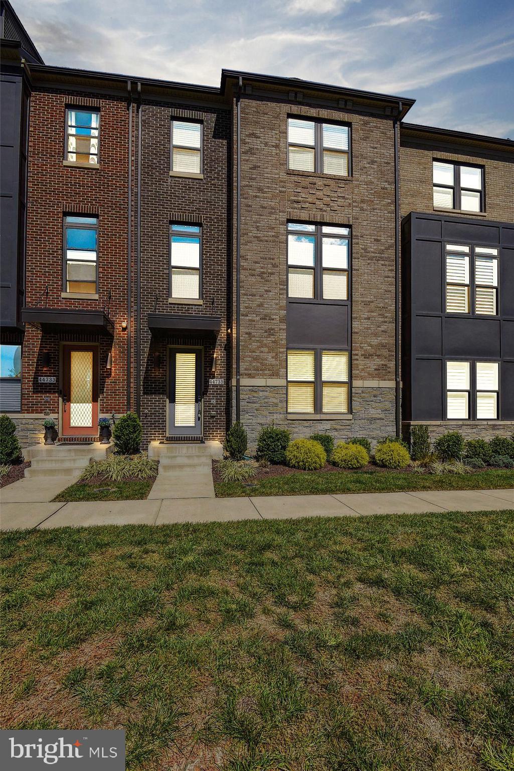 Beautiful 4 Level Stanley Martin 3BR, 2F/3H BA Townhome with oversized and finished 2 car garage-extra overhead storage shelves and storage room. Sunlit floor plan with volume ceilings, wood floors on 3 levels and courtyard view from the front. First level recreation room with beautiful wood flooring and entry level powder room.  

Elegant main level  features 10 foot ceilings, gourmet kitchen with expansive island and breakfast bar,  stainless steel appliance package, tons of cupboard space, plus large custom pantry. Appliances include  gas cooktop, double oven, built-in microwave, dishwasher and French door refrigerator over freezer.  Spacious dining room that could be dressed up or down depending on the occasion. Enjoy easy evening BBQs on the deck conveniently located just off of the kitchen.  Fantastic family room with  stone accent wall. Main level powder room. 

Owner's Suite with overhead ceiling fan/light, luxury full bath and walk-in closet. Luxury bath offers upgraded tile throughout, raised double bowl vanity and walk in shower with a bench seat. Private water closet. Bedrooms 2 and 3  with overhead light/ceiling fan and share the full guest bath with upgraded countertops and tile. Stackable Washer/dryer closet combination conveniently located on bedroom level. 

4th level loft/office with access to huge rooftop terrace. Additional powder room located on this level as well.  Security system with cameras throughout the home. 4 Mounted Flatscreen TVs convey. Furnace humidifier and 2 air filters.

Located conveniently across from downtown One Loudoun which offers a Trader Joe’s grocery store, multiple restaurants, movie theatre, boutique retail shops and more! There are a ton of One Loudoun community activities and amenities including the Club at One Loudoun with its resort style clubhouse, pool, tennis courts, walking/biking trails, sport court, sand volleyball court, soccer field, fitness trails, playgrounds,  farmers market on the weekends, community events at the Barn and much more.  Excellent commuter location with easy access to Dulles International Airport, Route 7, 28, Dulles Toll Road, and a few miles to the upcoming Metro Silver line stations.