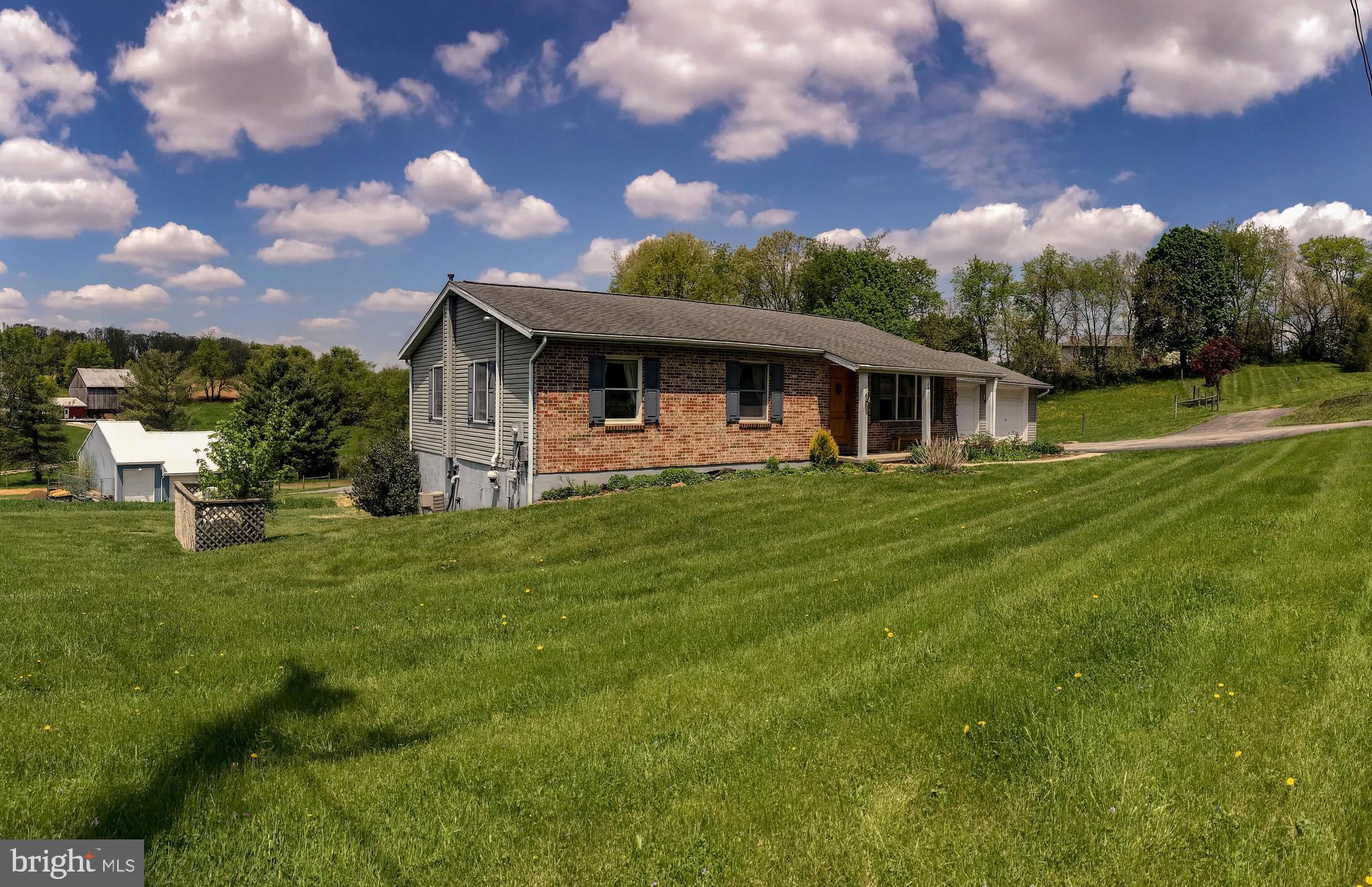 Well-maintained and updated 4-5 BR, 3 BA rancher perched on gorgeous 2-acre property offers fully finished basement w/possible separate living quarters.   Brand new deck overlooks fenced pasture and surrounding countryside.   Pole barn offers vehicle/tractor storage as well as 1 stall and tack room area, with room to add more stalls.  Barn offers run-in from fenced pasture,  electric and water, and fenced pasture has running water from a spring flowing through the property.  This would be perfect for your animals or for someone with lots of toys or equipment!  You will not be disappointed.