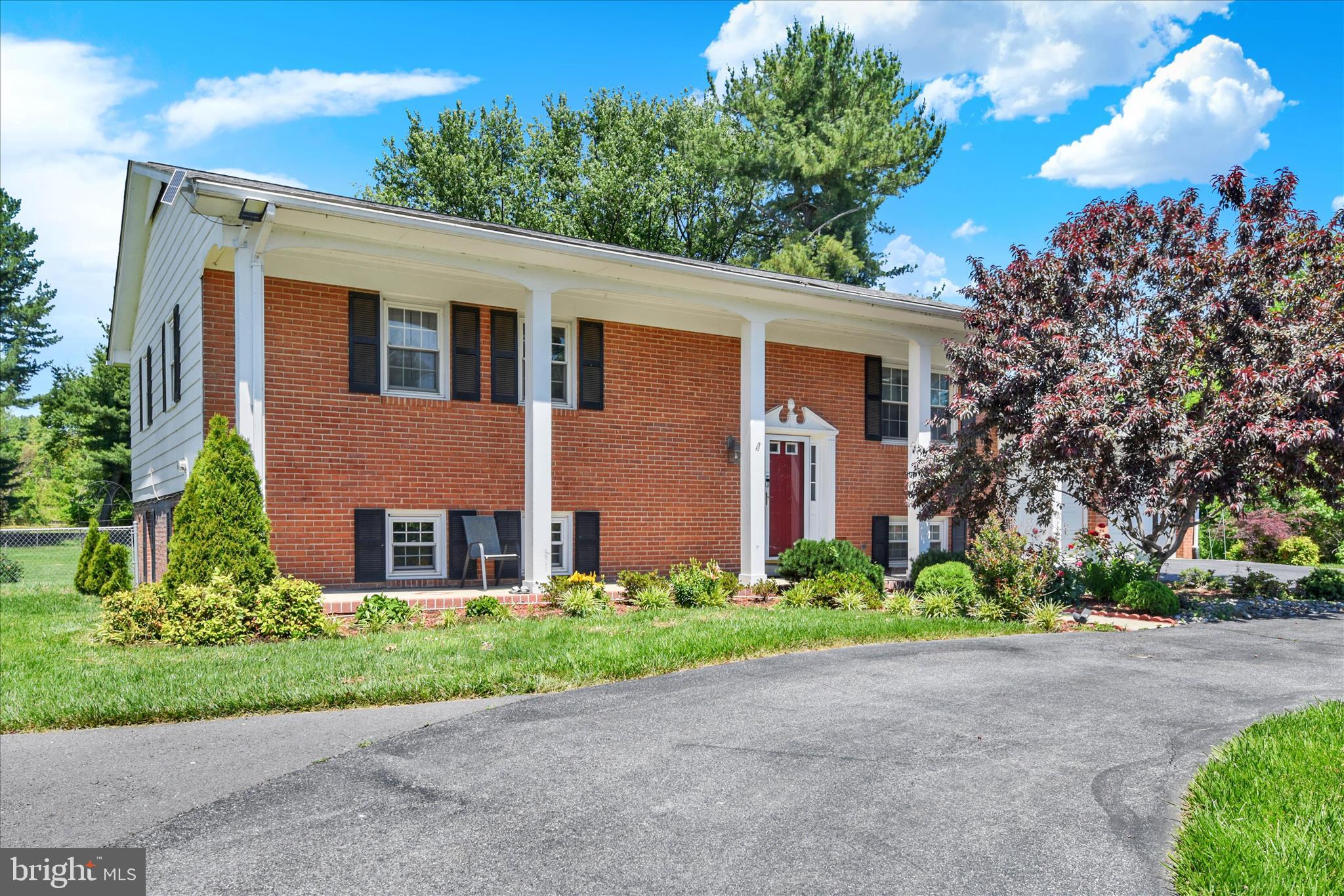Welcome to this nice and outstanding  home, this beautifully maintained 5-bedroom, 3-bath split foyer home offers outstanding curb appeal and a prime location.
The paved circular driveway, impressive front columns, and immaculate landscaping create a striking first impression. Step inside to a grand foyer that feels warm, welcoming, and spacious.
The main level features a primary suite, two additional bedrooms, a kitchen, dining room, family room, and sunroom.
The expansive walk-out lower level includes two large bedrooms, a full bath with a Jacuzzi tub and separate shower, a utility room, and a spacious family room. Herringbone-pattern ceramic tile flooring runs throughout the family room, where a wood-burning insert provides warmth and comfort. Creates a perfect gathering space for any occasion.
Located on approximately 0.9 acres across two parcels, the property offers open, level grounds surrounded by scenic farmland views and protected open space. The fully fenced backyard is ideal for children and pets. Relax on the stone patio with a fire pit, while enjoying breathtaking sunsets, or entertain family and friends in this peaceful outdoor setting.
Conveniently located within walking distance of grocery stores and just minutes from shopping, dining, the Golden Mile, and Downtown Frederick, this home combines privacy with accessibility. Enjoy Frederick County taxes only (no Frederick City taxes), along with well and septic service that eliminates monthly water bills.
Additional features include:
• No HOA fees or restrictions
• Attached two-car garage with automatic openers
• Abundant storage space beneath the sunroom
