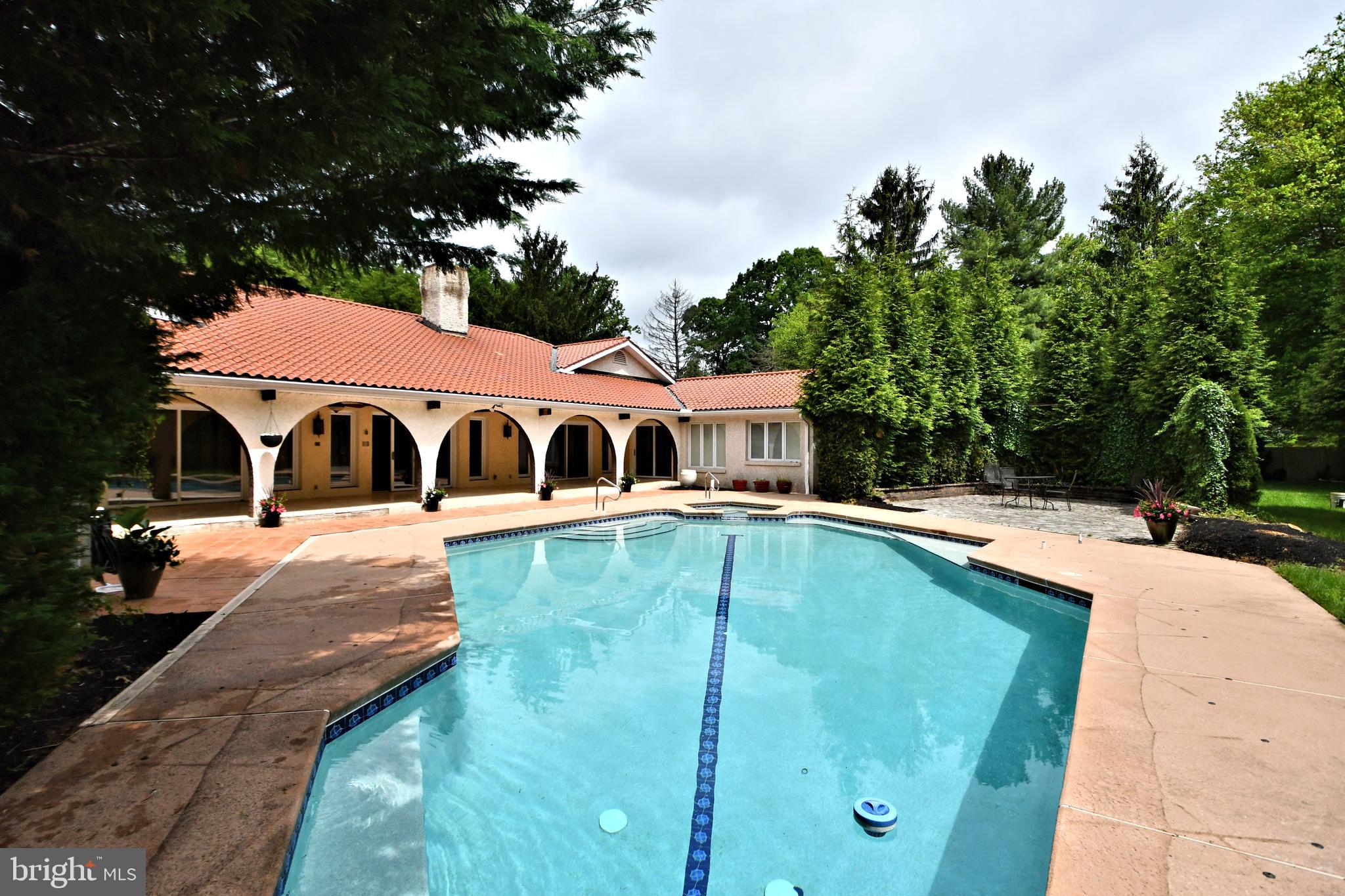 Welcome to this Mediterranean custom built ranch style home nestled on a private 1.19 acre lot, consisting of 5,214sqft of contemporary living space. This home has been revitalized from top to bottom including a new roof, refreshed interiors, and modern amenities. The bright, open layout flows effortlessly, highlighting gleaming floors, and modern design elements. 
 The inviting front courtyard opens into an expansive foyer with a stunning view of the rear yard and custom pool. The seamless floor design connects the living, dining, and kitchen areas, providing ample space for large celebrations as well as cozy evenings. Sliding glass doors span the entire rear of the home offering a seamless connection to the outdoors providing an indoor-outdoor living experience while flooding the space with natural light.
   The kitchen is a chef's dream, with clean lines and luxurious materials creating a space that is elegant as well as functional. Crisp white cabinetry, gleaming stainless steel appliances, and smooth white stone countertops bring a clean modern aesthetic to the space. The heart of this room is the stunning 14 foot island with it's expansive surface providing ample space for food prep, entertaining a crowd or a small casual meal. 
   Step into luxury with this home’s new primary en suite, designed to be your personal retreat. This spacious bedroom features an abundance of windows and sliding doors that open directly to the backyard, creating a natural connection to the outdoors and filling the space with natural light. The spacious walk-in closet offers plenty of hanging space and shelves to easily store and organize all your belongings. The recently completed bathroom is a showstopper, with an elegant freestanding tub, spa-like shower, stylish vanity with double sinks, and sleek modern fixtures. The east wing is exclusively dedicated to accommodating two additional bedrooms, each featuring its own bathroom for added convenience and comfort. 
 The west wing is dedicated to a welcoming and private guest ensuite, generously sized laundry room, a powder room, and a spacious and elegant dining room perfectly suited for hosting unforgettable holiday feasts and cherished family gatherings. The new patio off this area extends the home’s indoor-outdoor feel, seamlessly blending the living space with it's natural surroundings.
   Descending into the finished basement, you'll discover a world of possibilities. Whether it's a spacious entertainment area with home theater, fitness center, wine cellar, or a guest suite, there's plenty of room to tailor the space to your lifestyle needs. You will also find the convenience of a full bathroom as well as a powder room ensuring comfort and accessibility for you and your guests.  There is an additional 1873sqft for either storage or to expand the finished area, offering versatility to suit your needs and preferences.
   The rear yard is the ultimate retreat with a 55sqft pavilion leading to a custom inground pool with spa. Whether it's hosting a summer BBQ or preparing a simple meal, the outdoor gas kitchen is the perfect place to cook, dine, and entertain in style. Multiple patios offer serene spots for dining, lounging, or entertaining. With its carefully curated details, this space seamlessly blends luxury and comfort, creating a peaceful haven just steps from your door.
   This one-of-a-kind property is versatile inside and out, offering the perfect setting for both intimate moments and lively gatherings. With easy access to major roads, commuting is a breeze, while the nearby tranquil golf courses provide a peaceful retreat right outside your door. Whether you’re heading out for work or enjoying a relaxing afternoon on the greens, this location offers the best of both worlds.