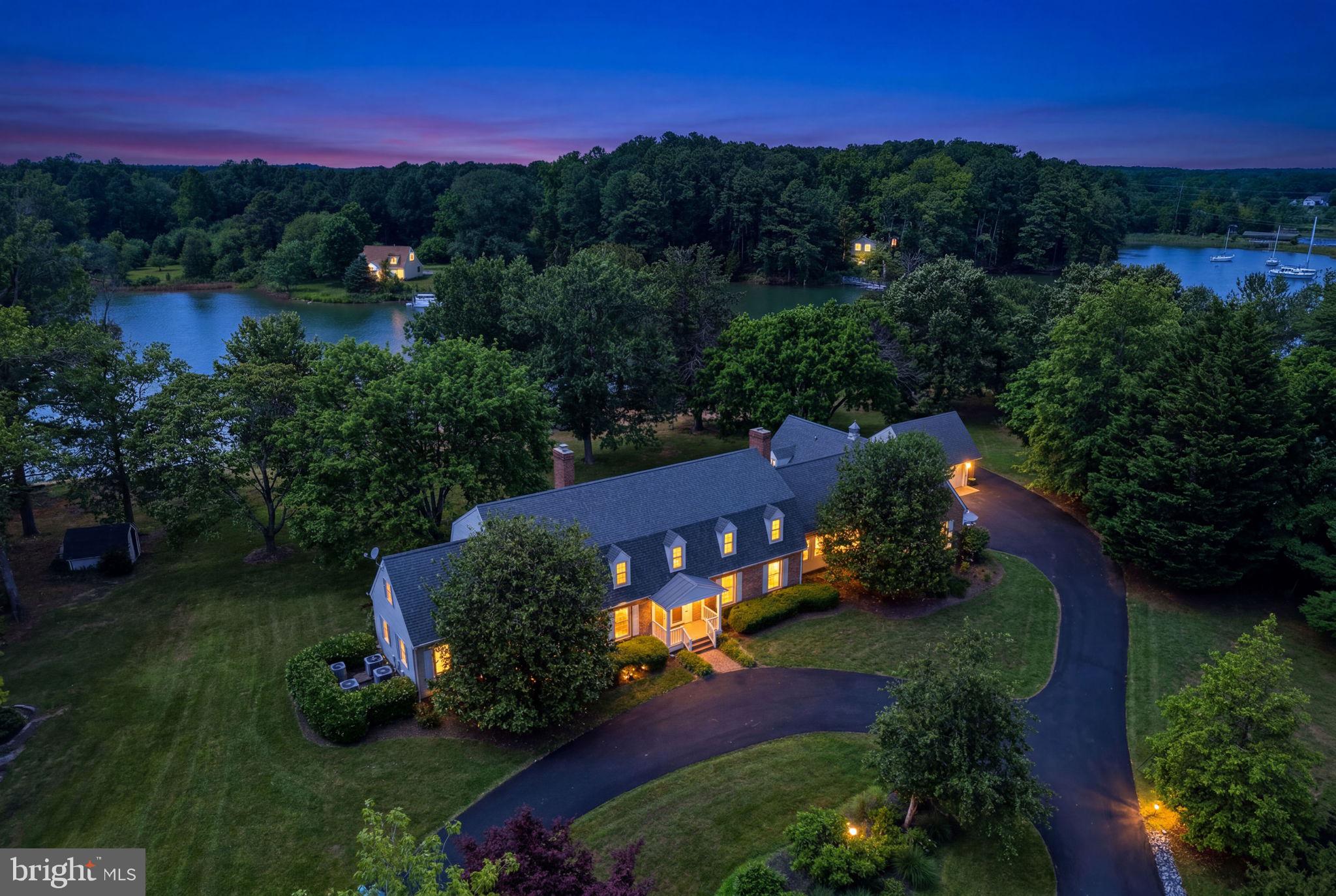 Nestled on a gorgeous waterfront lot just minutes from St. Michaels, this exceptional property offers the perfect blend of privacy, comfort, and convenience. Enjoy an easy bike ride into town while coming home to a peaceful setting surrounded by mature, established trees and beautifully landscaped grounds.
Built with quality and designed for comfortable living, the home features two spacious primary suites, including one conveniently located on the first floor. Large walk-in closets provide abundant storage throughout. An attached in-law suite offers flexibility for extended family, guests, or multi-generational living. The impressive foyer welcomes you into a thoughtfully designed floor plan featuring mostly hardwood floors throughout. Enjoy a spacious dining room perfect for large family gatherings, a comfortable living room anchored by a cozy brick fireplace, dedicated office space, and a separate craft room. A large utility room provides exceptional functionality with space for an extra freezer and refrigerator, while multiple HVAC zones ensure comfortable heating and cooling throughout the home.
Outdoor amenities are equally impressive. Relax by the pool, entertain on the waterfront, or take advantage of the private dock with approximately 4 feet of mean low water depth. The property also includes a substantial workshop with tractor storage, ideal for hobbyists, boaters, or those needing extra workspace.
Recent improvements provide peace of mind, including a roof that is just two years old and a paved driveway completed within the last year.
This is a rare opportunity to own a solidly built waterfront retreat offering space, functionality, and timeless Eastern Shore charm just moments from the shops, restaurants, and waterfront attractions of St. Michaels.