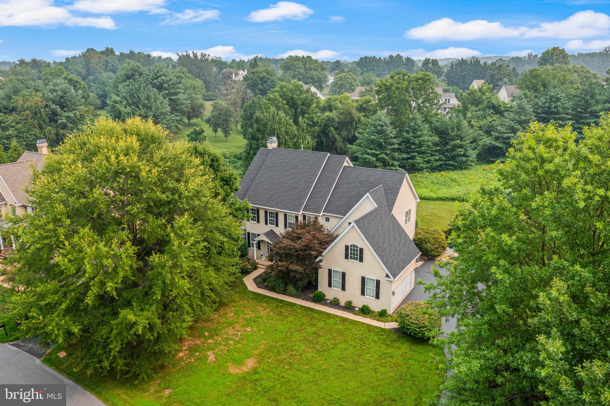 Perfectly positioned on one of the community's most desirable homesites, this exceptional residence is set back from the street and bordered by dedicated open space on two sides, offering a rare sense of privacy and picturesque surroundings. Overlooking a beautiful wildflower meadow framed by mature blue spruce and towering pine trees, the backyard provides a peaceful, elevated setting unlike any other. A spacious three-car garage and oversized driveway, shaded by a row of mature trees, create an impressive arrival. Inside, a gracious two-story foyer welcomes you into a light-filled home featuring nine-foot ceilings, new hardwood flooring throughout the living and family rooms, and a private first-floor library ideal for today's lifestyle. The beautifully updated kitchen is the heart of the home, showcasing an oversized quartzite island with matching countertops, updated appliances, and double wall ovens, making both everyday living and entertaining effortless. French doors lead to a spectacular outdoor living space featuring a redesigned stone patio and terrace overlooking the scenic landscape, while a newly restored cedar pergola draped in wisteria, roses, trumpet vine, and clematis creates the perfect setting for outdoor dining and gatherings. Upstairs, the spacious layout offers four generously sized bedrooms, three full bathrooms, and the convenience of an upper-level laundry room. Thoughtfully maintained with significant recent improvements, including a new roof (2023), new upstairs and downstairs HVAC systems (2024), and a fully restored pergola (2025), this remarkable home seamlessly blends timeless elegance, modern updates, and an exceptional setting rarely found within the community.  Award-winning Kennett Consolidated SD and easy access to bustling Kennett Square Borough, this amazing home is sure to impress!