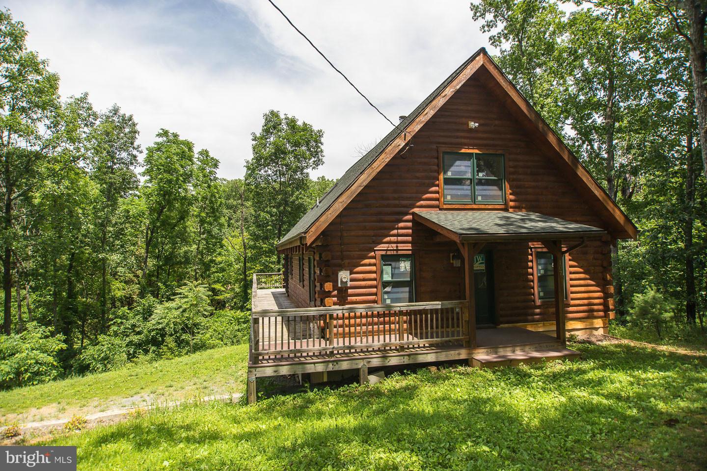DRASTIC PRICE REDUCTION!  Amazing Log Home,View Of And  Lake Front W/Dock, Finish This Home And Add Your Touches! Log Interior/Exterior, Floor To Ceiling Fireplace,  Loft BR With Full Bath Plan, 2 BRooms On Main Level Each With A Bathroom Plan, Large Open Family Room Kitchen/Combo, With Wood Beams, Spacious Basement With Walk Out To Back Yard And Full Bathroom! Sellers bids to finish $40,000