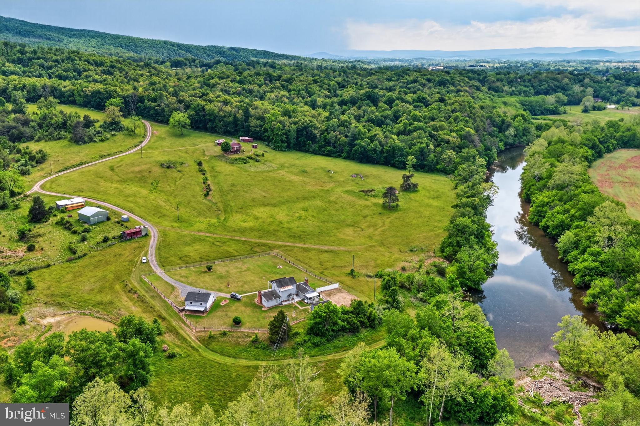 Nestled along the scenic Shenandoah River, this extraordinary  39 acres* property offers a rare combination of privacy, natural beauty, and multi-residence flexibility.  Featuring two separate residences, the estate is ideally suited for multi-generational living, rental income opportunities, or a private family retreat.   The colonial house has 3 bedrooms and 3 full baths and the ranch style house has 3 bedrooms 2 full baths.
The property boasts exceptional river frontage along the Shenandoah River, providing direct access for fishing, kayaking, canoeing, or simply enjoying the peaceful waterfront setting.  A beautiful spring-fed pond enhances the landscape and creates an additional focal point for recreation and relaxation.
Infrastructure is already in place with three wells and two separate septic systems, offering convenience and versatility for current and future use.  Additional improvements include a detached garage and multiple storage buildings/sheds, providing ample space for equipment, hobbies, workshops, or outdoor gear.
With a blend of open space, mature trees, water features and usable acreage, this one of a kind property presents endless possibilities- whether envisioned as a private estate, family compound weekend getaway, equestrian property, or investment opportunity in the heart of the Shenandoah Valley.