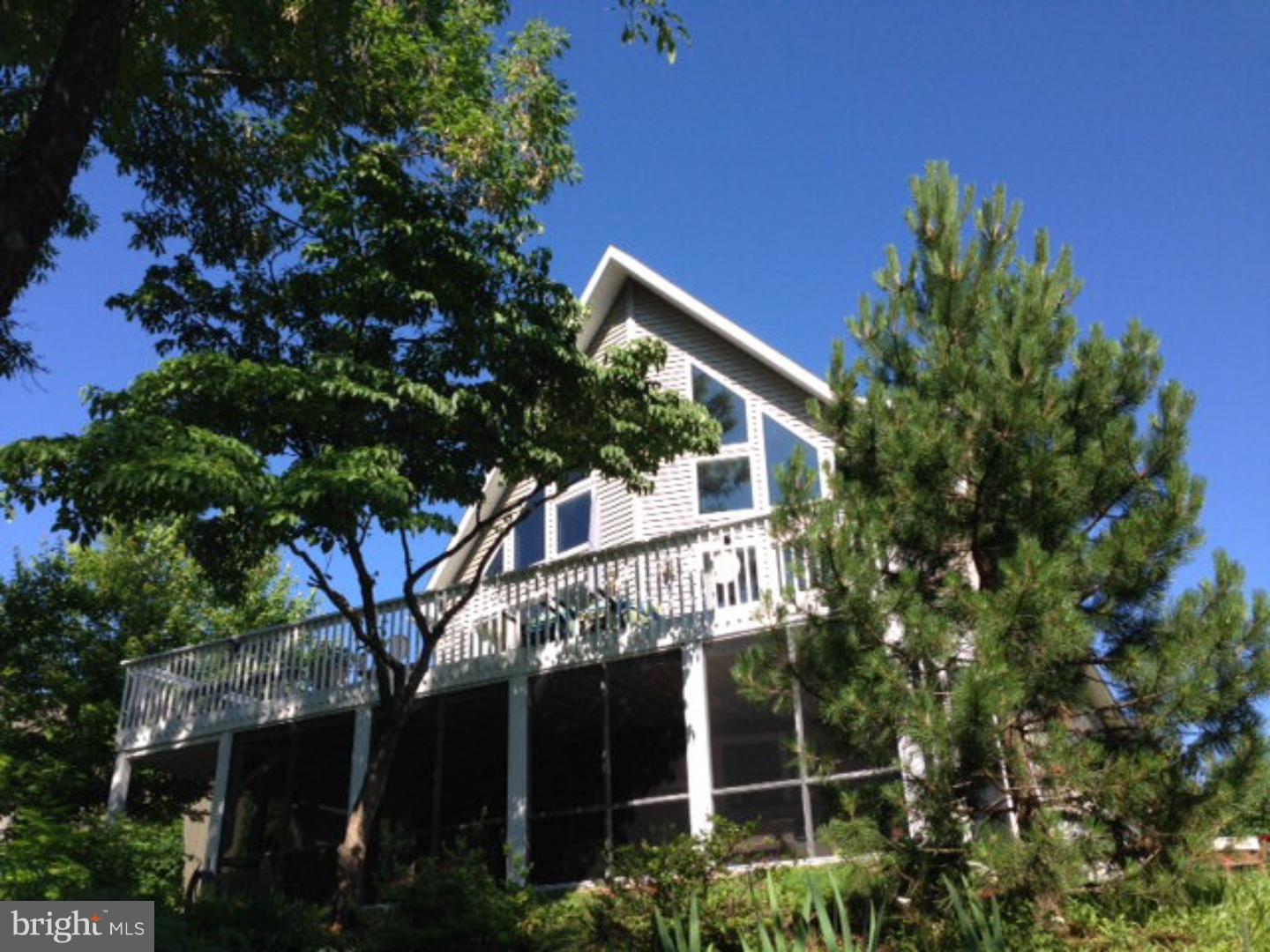 BEAUTIFUL LAKEFRONT CHALET w/70-feet of Lake Frontage, 2 Docks, and a Boathouse. Plenty of Windows Flood the Home with Natural Light! Open Floor Plan, Living Room Fireplace. Central Air. First Floor Laundry Room adds Convenience. Private Guest Suite for Visitors. Screened-In Porch with Hot-Tub Looks Out Onto the Lake. Completely Finished Lower Level Leads to Enclosed Porch. 2-Car Attached Garage.