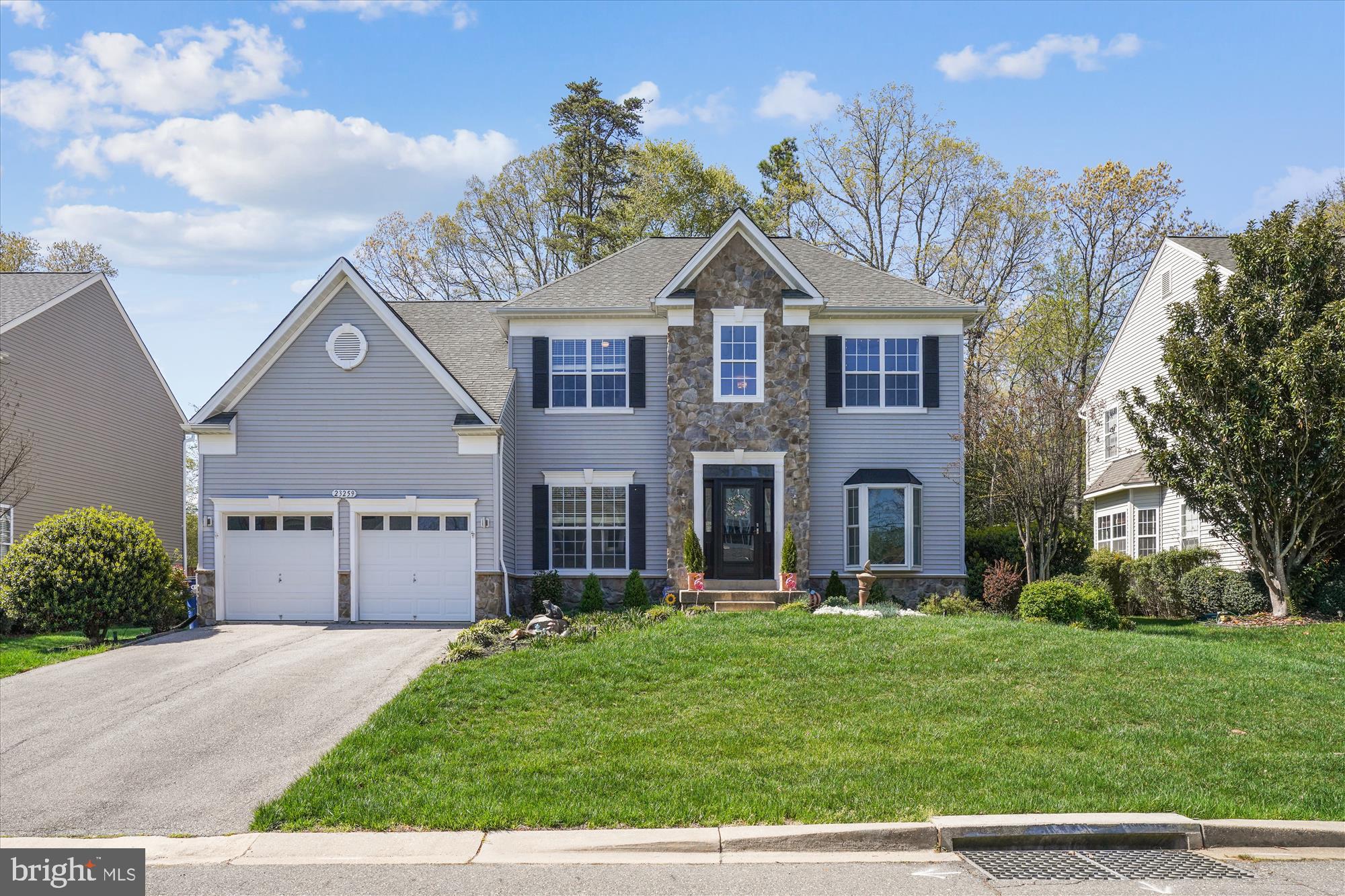 DRIVE BY AT NIGHT TO SEE ALL THE EXTERIOR LIGHTING AROUND THE HOME. Stunning 5BR/3.5BA colonial with stone accents and two-car garage located in Estates at Singletree. This model features an open floor plan spanning approximately 4,000 square feet on three levels and offers a great sense of light and spaciousness with 9-foot. ceilings and floor-to-ceiling windows on the main level. Designer décor with custom painting; elaborate three-piece chair rail, crown, and shadow box molding; luxury vinyl wide-plank flooring on the main level; custom window treatments, upgraded and recessed lighting, surround sound, and brushed nickel door hardware and hinges throughout. Gourmet kitchen with granite countertops, tile backsplash, and oversized granite center island/breakfast bar. Remodeled bathrooms throughout with ceramic tile flooring and tub/shower wall surround.  Private resort-like outdoor space with exterior lighting throughout, two-level composite and vinyl deck, pergola, two brick paver patios, firepit, putting green, custom outdoor bar structure with granite countertops and shed-like storage area, and outdoor speakers. Professional landscaping features custom hardscape, specimen trees, ornamental shrubs, and uplighting to complete your slice of paradise. 
Inviting entryway with front door, upper & side transom windows, and storm door leading to two-story foyer; glass French door entry to study/music room with ceiling fan; living room with recessed lighting and floor-to ceiling bay window; dining room with recessed lighting, double window, and chandelier; gourmet kitchen with 42-inch raised-panel cabinets with under cabinet lighting, granite countertops, designer tile backsplash, upgraded Samsung stainless appliances, oversized granite center island/breakfast bar, desk/workstation, recessed lighting, and pantry closet; breakfast area with chandelier and glass slider to private backyard oasis; family room off of kitchen with a wall of windows, recessed lighting, and a floor-to-ceiling stone fireplace with electric insert; main level laundry area off of garage and powder room with ceramic tile flooring, vanity and wainscotting; hardwood staircase to upper level landing with two closets; primary bedroom suite with tray ceiling, private sitting area, massive walk-in closet with custom shelving; primary bath with double-door entry, designer ceramic tile flooring, vanity with dual undermount sinks, quartz countertops, linen closet, two-person Jacuzzi whirlpool tub with ceramic tile tub deck, and separate walk-in ceramic tiled shower with glass enclosure; three additional bedrooms on this same level with double-door closets and ceiling fans; remodeled hall bathroom with wood-like tile flooring, vanity with quartz countertops and dual sinks, upgraded lighting and bath fixtures, and tub/shower with tile surround and frameless glass enclosure.  Fully-finished walk-out lower-level recreation room/game room with carpet and ceramic tile, wet bar with cherry cabinets and two under counter beverage centers, recessed lighting, storage closet under stairs; bedroom with full window, and ceiling fan; remodeled full bathroom with walk-in shower; den with double-door entry, recessed lighting, and custom built-in shelving; BONUS movie theater/media room with surround sound pre-wiring. The Estates at Singletree is approximately one mile to quaint downtown Leonardtown to enjoy restaurants, bakeries, coffee shops, and live music on the square. The Library, Elementary School, and Senior Center are all nearby.  Or head down to Breton Bay and Leonardtown Wharf to enjoy the park, playground, fishing, free boat dock, ice cream, and gorgeous sunsets. **Family Pool memberships are available at the nearby Breton Bay Country Club.