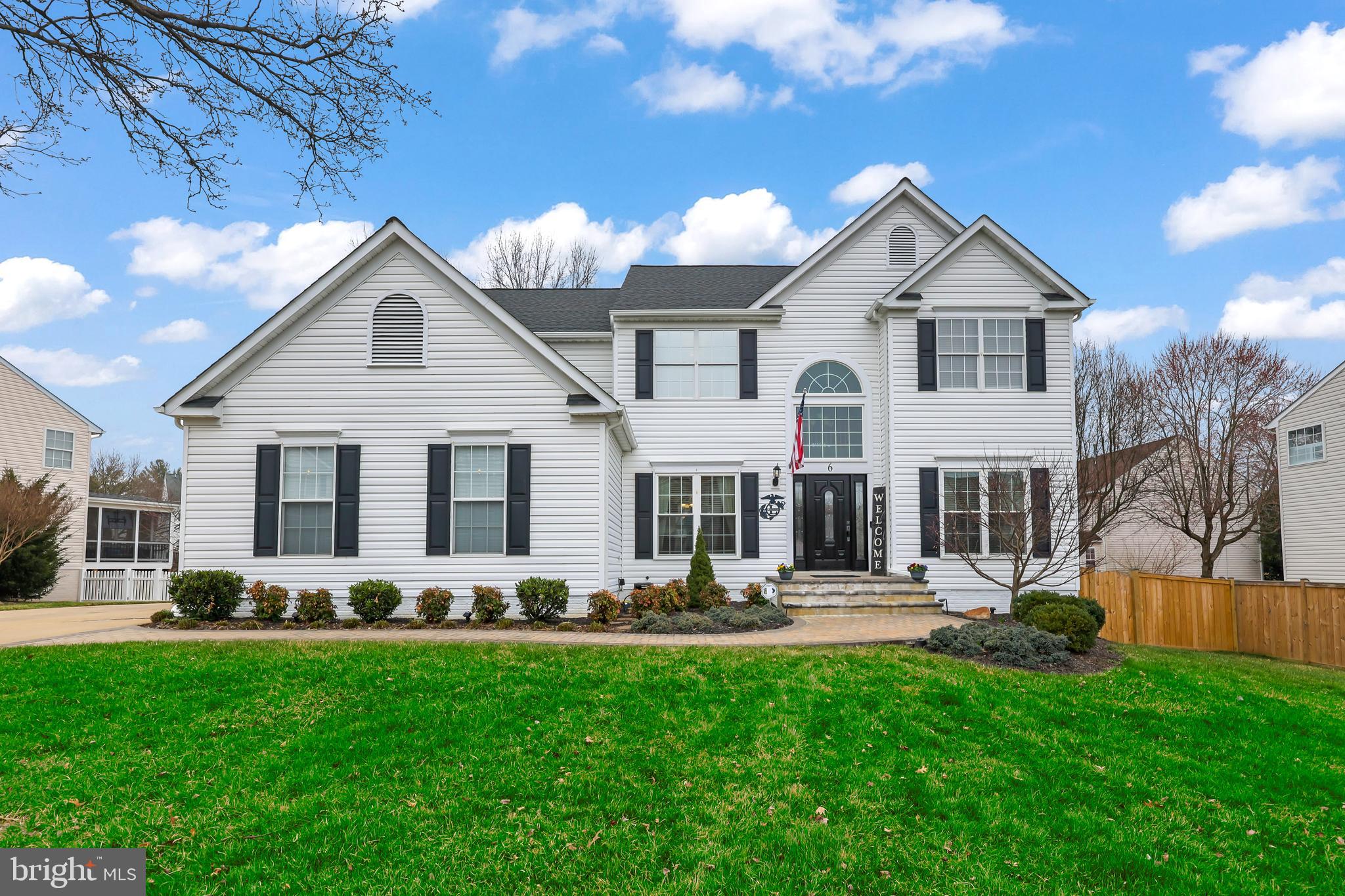 Welcome home to this stunning Colonial in the Hampton Oaks community. As you enter, elegant columns and gleaming hardwood floors greet you into this 4000+ finished square foot home. A convenient home office and elegant dining room both welcome you in. But it's the open floor that is truly impressive. The two story family room boasts tons of natural light and opens to the gourmet kitchen. The family room, with its gas fireplace and new ceiling fan, provides peaceful views of the backyard. The eat-in kitchen includes many special features: recessed lighting, a spacious island with pendant lighting above and shelving at the end, a modern backsplash, stainless steel appliances including new double wall ovens and a gas cooktop, a reverse osmosis water faucet, and a walk-in pantry. A mudroom, separate laundry room and half bathroom complete this level. The upper level continues the natural light with it's overlook of the family room. Four bedrooms are located here including the primary bedroom suite that boasts recessed lighting, ceiling fan, two walk-in closets, and double doors to the spa-like bathroom suite. Recently renovated, this bathroom has ceramic tile flooring, dual sinks, upgraded cabinetry, mirrors that open that have their own outlets in each one, new toilet, a frameless walk-in shower with tile flooring, and garden tub with a chandelier above. The other three bedrooms are all well-sized with ceiling fans and ample closet space. Make your way down to the fully finished basement for even more room. With a good-size bedroom (NTC) and a full bathroom located here, it's a great space for guests. The cozy rec room is another area to relax. But wait till you see the funnest part of the home. Open the french doors to your entertainment oasis. Hours of entertainment in the gaming areas, built-in cabinets with mounted tv, built-in speakers and a custom made bar with sink and fridge. Another reverse osmosis water filter faucet located at the bar. There is also an unfinished area with shelving which is perfect for storage. Besides grilling and entertaining on the deck, the deck has built-in seating overlooking the backyard. There is plenty of room for backyard activities, including the perfect spot to hang your hammock and a convenient shed. The two car, side-load garage has a woodworkers area - so bring your tools! The homeowners have loved their Culligan water service which can be transferred over to the new buyers. NEW improvements include: new back door to deck with built-in blinds, the six foot, wooden rear fence, and A/C on main level & basement (2024), the primary bathroom suite remodeled and new hot water heater (2023), gas furnace rebuilt (2020), and new roof and primary bedroom & bathroom windows (2018).  This home is in a perfect neighborhood location because you can walk to the community center, outdoor pool, tennis and pickleball courts, and tot lots. Just a few minutes away from the elementary school, and shopping and dining. A great bonus is the slug line to DC, Pentagon, and Quantico is very close as well as 95. Hurry, you don't want to miss this opportunity in Hampton Oaks!