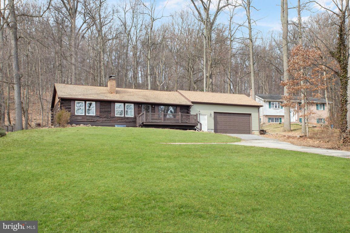Dream of owning a log home?  HERE YOU GO!  This stunning rancher has been recently updated and is situated on a 1 acre lot.  The big front porch is perfect for having your morning coffee  while overlooking the scenic views!  The moment you step inside, the log walls and exposed beams in this home make you feel warm and cozy.  The Brand new Luxury Vinyl flooring carries  throughout the home.  The living room has a brick wood burning fireplace and is open to the dining and kitchen which includes all of the appliances.  2 bedrooms upstairs (one with a cedar closet), and a nice full bath with double sinks makes getting ready in the morning easy.  Downstairs there is a family/rec/game room and there is also another bedroom and another full bath making it a great area for guests as well. Brand new furnace heat pump with central air, will keep you cool this summer, and the brand new septic tank gives you peace of mind.  Outside, the trees surround you and makes this a dream setting.  This log home offers you all of the charm you would expect and so much more.....