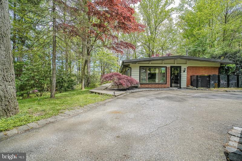 Welcome to this beautiful move-in condition wooded expanded rancher near the Main Line in prime Upper Merion School District in Wayne.  Large inviting front driveway surrounded by an abundance of foliage.  Walkway to formal front entrance and side door entrance.  Formal family room with ceiling fan, custom shelving, and hardwood floors.  Large modern eat-in kitchen with breakfast room, skylights, stool sitting bench, s/s refrigerator, dishwasher, gas(propane) cooking range, ceramic tile, and hardwood floors.  Large formal dining room with fireplace and hardwood floors.  Master bedroom with modern master bath,stall shower with new sink top .  2nd and 3rd bedrooms, modern hall bath.  Exit to several patio sitting areas, deck, and stunning yard views.   Newer state-of-the-art high efficiency heating system, mostly modern windows.   Close to Roberts Elementary School, King of Prussia Mall and Town Center, 202, 76, and Wayne/Strafford train stations.  This is a great price point for the area !! Don't hesitate !!