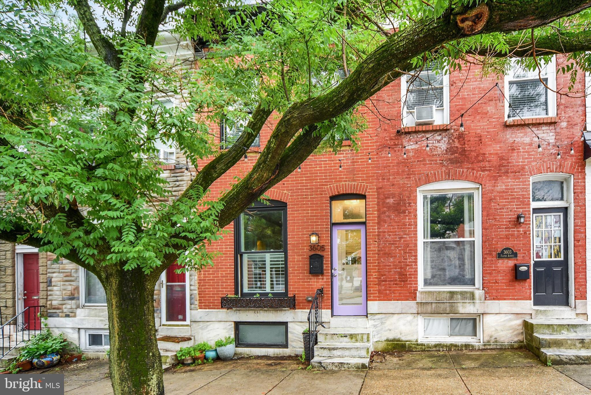 Beautifully reimagined Brewer’s Hill rowhome blending timeless historic character with curated modern updates, this one of a kind property includes valuable CHAP tax credits, resulting in an exceptionally low 2025 tax bill of approximately $1,700.

Offering nearly 1,800 square feet of finished living space across four bedrooms and three full baths, this home showcases a rare combination of preserved architectural charm and elevated design. Restored historic details include an original decorative mantle, elegant columns, exposed brick, intricate trimwork, hardwood floors, and the original staircase. Modern enhancements such as tray ceilings, recessed lighting, custom built-ins, and an open-concept layout ensure a seamless blend of character and function.

The updated gourmet kitchen features quartz countertops, stainless steel appliances, abundant cabinetry, and an oversized island. Upstairs, the spacious primary suite includes a renovated bath with a custom-tiled walk-in shower, complemented by an additional bedroom and full bath on the same level. The fully finished lower level provides two more bedrooms, a full bath, laundry, and flexible living space.

The outdoor spaces include a private patio courtyard featuring a striking Michael Owen original mural inspired by Baltimore’s iconic LOVE Project, an elevated rear deck, and a rooftop deck with sweeping city views.

Ideally situated on a wide block with easy street parking in sought-after Brewer’s Hill, this home is a short walk from Canton Crossing, Patterson Park, and waterfront dining. This is a rare opportunity to own a piece of Baltimore history with complete modern comfort.