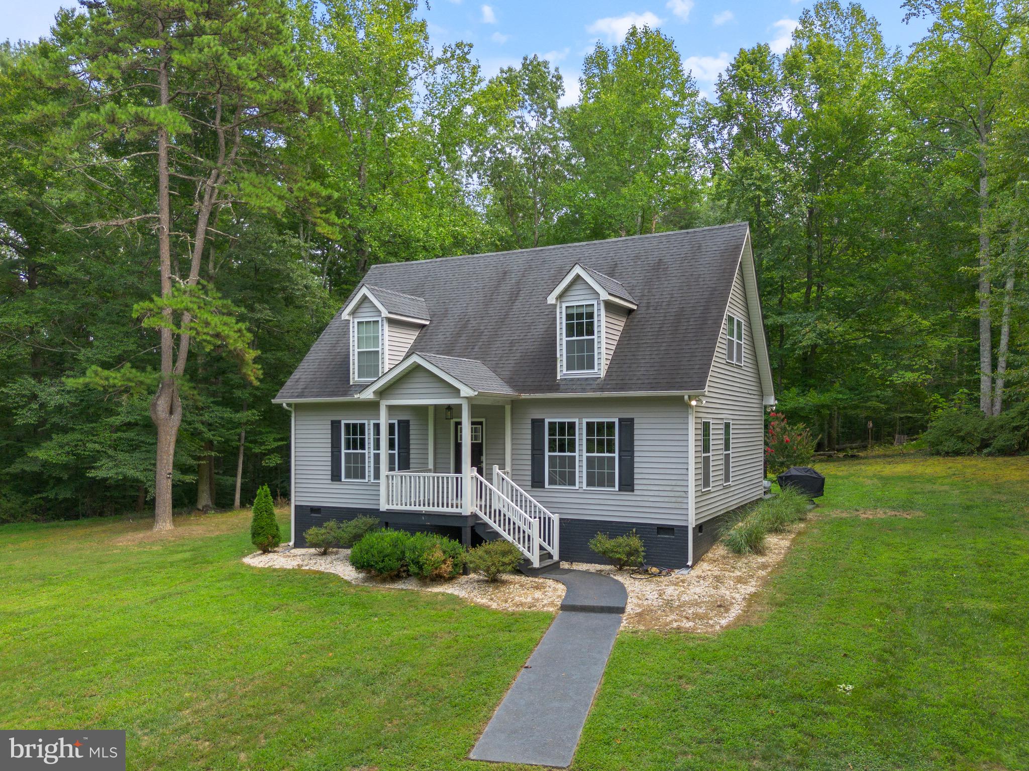WELCOME HOME! As you turn onto the driveway and wind through the woods you will instantly feel like you've escaped. Tucked back from the road on five and a half acres (only minutes from Route 29 North, NGIC, Charlottesville, restaurants, shopping and Shenandoah National Park) your quiet haven awaits. This 3 bedrooms, 2 1/2 baths Cape Cod boasts stainless steel appliances, granite countertops, and many more features. The  property was fully remodeled in 2018 and well cared for inside and out.  When you step into the open living area you are greeted by walls of windows and a comfortable living room leading to a well laid out kitchen and dining area with access to the large back porch. In the hallway is a large pantry then a convenient half bathroom that houses the washer and dryer. The large primary bedroom on the main floor features more windows and an accent wall with over 100 year old barnwood as well as roomy closets and a luxurious bathroom complete with a shower, jetted bathtub, and a separate toilet area. Upstairs, there is a landing that is perfect for a reading nook and another full bathroom as well as the spacious second and third bedrooms with walk-in closets. This home has many windows that bring in plenty of natural light and look upon the wooded landscape. When not relaxing in this calm and peaceful escape there is that added convenience of fast and reliable fiber internet. Come see this unique property today!