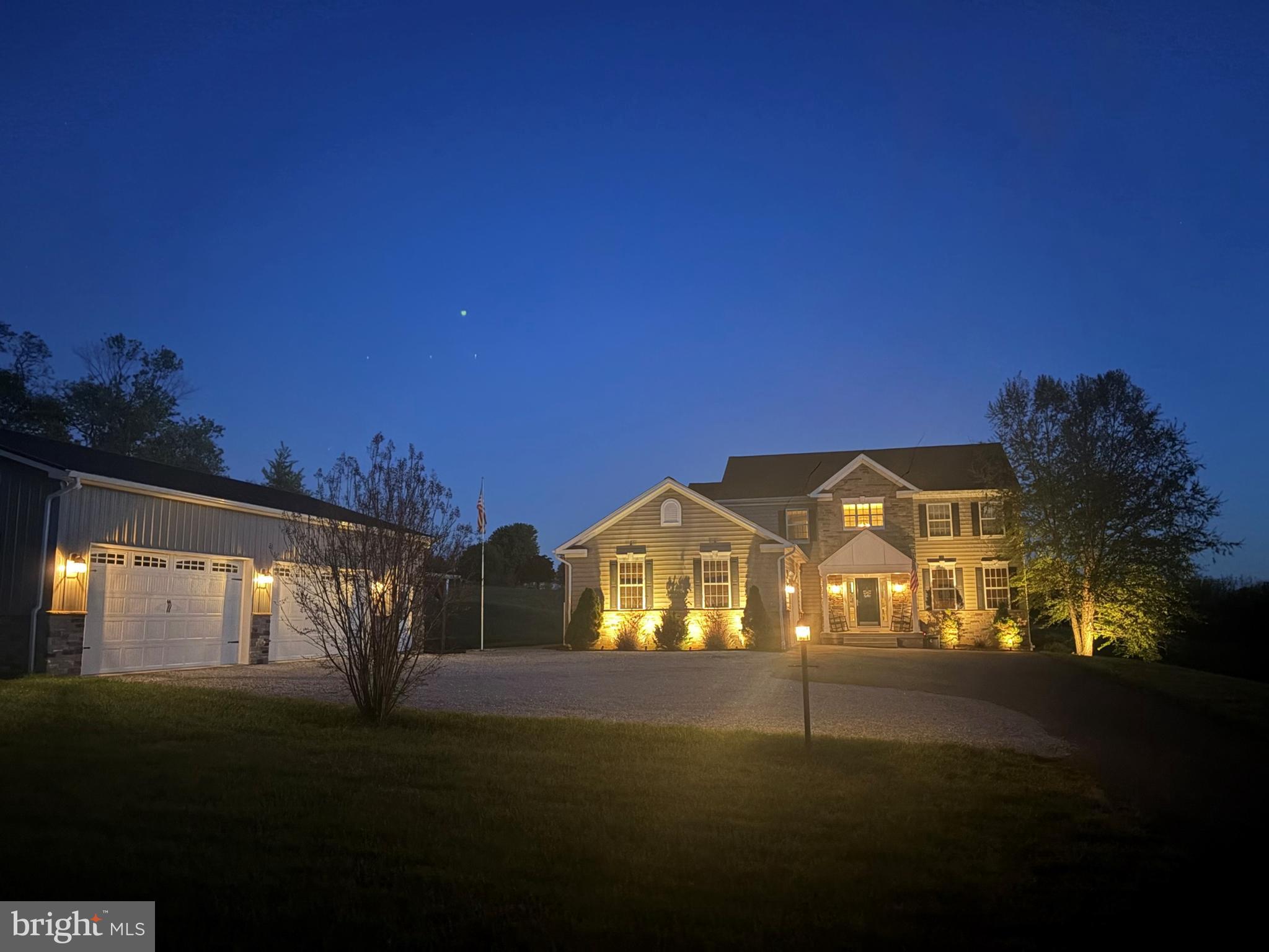 A touch of paradise awaits in this stunning custom-built home where luxury, comfort, and thoughtful design come together beautifully. This is a place where dreams can flourish and memories can be made. From the moment you enter, you’ll appreciate the elegant open floor plan, rich wood flooring, and detailed wainscoting that create a warm yet sophisticated atmosphere throughout.
The heart of the home is the spectacular gourmet kitchen featuring granite countertops, stainless steel appliances, a large center island, oversized farmhouse sink, walk-in pantry, and abundant cabinetry. The kitchen opens seamlessly to the dramatic two-story family room highlighted by a soaring fireplace with a 52,000 BTU Harman pellet stove insert capable of heating the entire home while helping reduce energy costs.
Formal and functional spaces blend perfectly with a beautifully appointed dining room, private office with wood floors, convenient main-level bedroom, and a full elegant bath ideal for guests or multigenerational living. The laundry room includes a large farmhouse sink with custom cabinetry for added convenience.
Upstairs, two secondary bedrooms are connected by a full bath and overlook the family room via a charming bridge walkway leading to the luxurious primary suite. The spacious owner’s retreat is filled with natural light and features a ceiling fan, walk-in closet, and spa-inspired en-suite bath with dual vanities, separate makeup area, and an oversized 7.5’ x 7.5’ custom shower.
The walk-out lower level offers endless possibilities with rough-in plumbing for a future half bath and abundant space ready for your finishing touches.
Additional premium features include:
-Whole-house water treatment system 
-Reverse osmosis water filtration to kitchen sink and refrigerator 
-Home Team Pest Defense in-wall insect control system 
Step outside to enjoy truly exceptional outdoor living spaces with mature landscaping, sunlit patios, and breathtaking sunset views. Entertain with ease on the brick paver patio and pavilion wired for audio and outdoor sound.
The impressive 28’ x 48’ fully insulated pole barn is climate controlled with both heat and A/C and features a custom-built molecularly modified wood barn door designed to resist water and rot. Two additional 3” underground conduits have already been installed for future utility expansion.
This extraordinary property offers the perfect blend of elegance, functionality, and peaceful living — ready to welcome its next owners home.