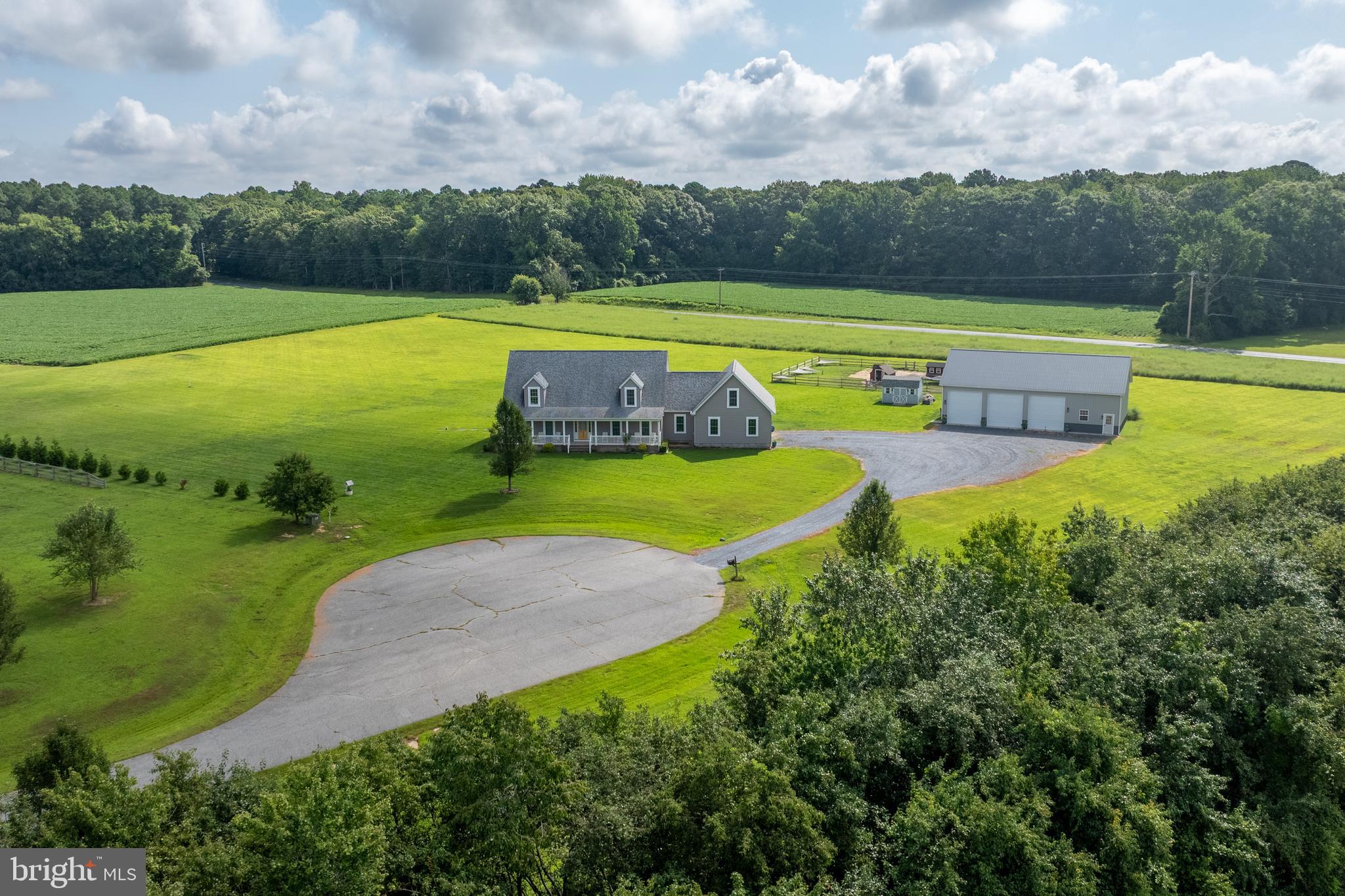Custom-built Cape Cod on 22.69 acres in the desirable McShell Glenn community! This charming home welcomes you with a full-length front porch and an inviting open floor plan. The gourmet kitchen is a true highlight, featuring stainless steel appliances, a breakfast bar, and a spacious walk-in pantry, seamlessly connecting to the dining room and family room—perfect for entertaining.

The first floor boasts a private primary suite with a luxurious en-suite bath, walk-in closet, personal laundry room, and office. An additional office, second laundry room, and thoughtful layout provide convenience and flexibility. Upstairs, you’ll find a cozy sitting room, two oversized bedrooms, and a full bath. A large unfinished bonus space offers endless possibilities.

In addition to the attached 2-car garage with workspace, this property includes a 30'x60'x14 post-frame building with concrete floors and electric—ideal for hobbies, storage, or a workshop. Outdoor living shines with a brand-new custom paver patio, with plenty of space to add an in-ground pool.

Farmette on over 22 acres where hunting and horses are permitted, this property offers the best of privacy and convenience—just 5 miles from downtown Easton’s shops, dining, schools, and more.