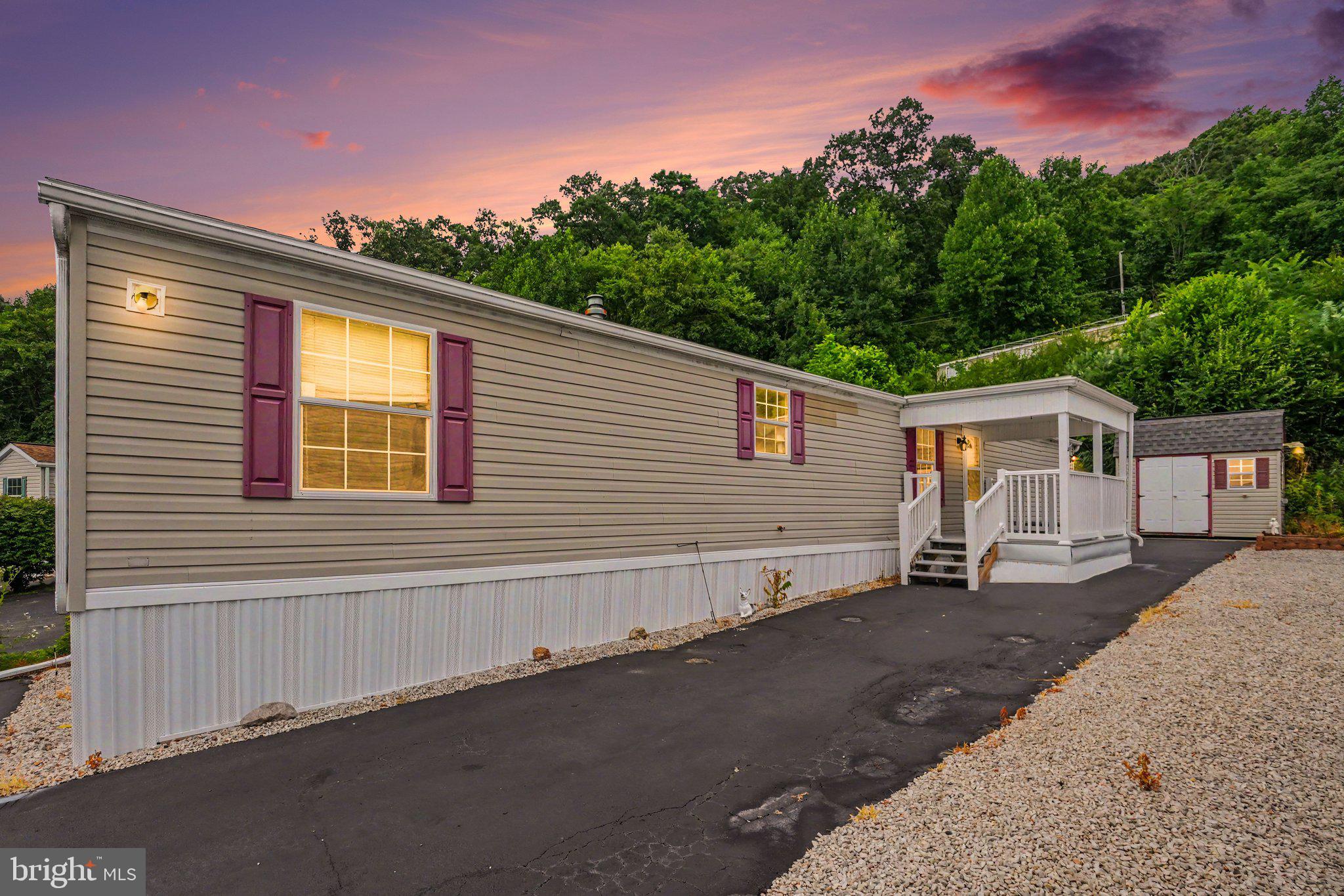 Nestled in the desirable 55+ Urban Acres Community, this well-maintained home offers the perfect balance of peaceful living and everyday convenience. Inside, you'll find a comfortable floor plan with a spacious living room, an eat-in kitchen with ample cabinet and counter space, two nicely sized bedrooms, and a convenient laundry area. Enjoy your morning coffee on the covered front porch or unwind on the rear patio overlooking mature trees. Complete with central air, a storage shed, and a paved driveway, this home is just minutes from Route 12, shopping, dining, healthcare, and everything you need.
