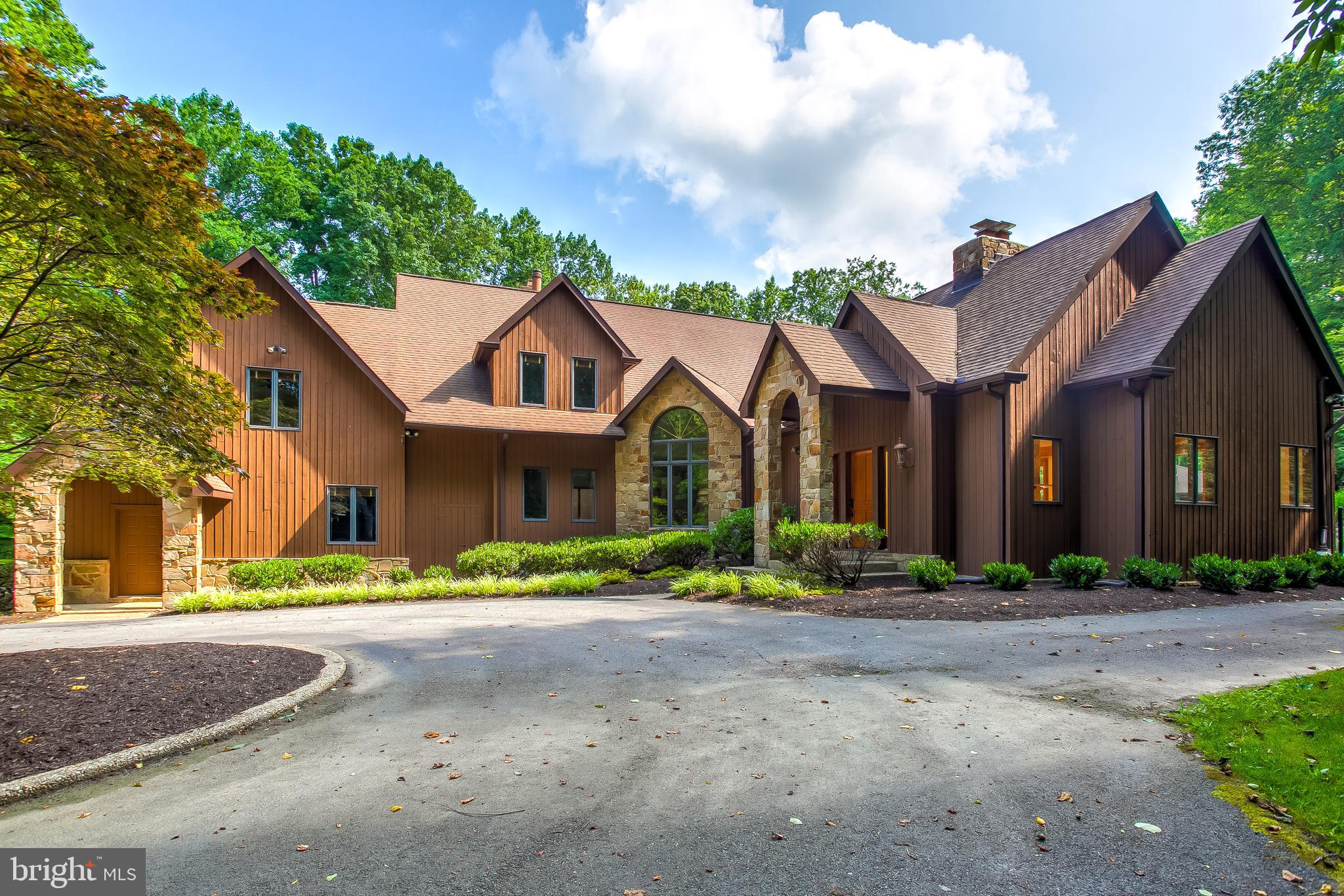 Ultimate staycation home set on a gorgeous 3 acre lot, enveloped by mature woods is ready to enjoy and impress! Amazing exteriors include a custom pool house with a full bath and full outdoor kitchen, an in-ground saltwater pool with two waterfalls, integrated slide, lights, heaters, jets, and an indoor Swimex pool and Jacuzzi - popular for regular exercise and also as a hydrotherapy pool, a retractable screened-in porch, large detached workshop, and sport court with tennis, volleyball, and basketball court settings! Enter the home to find open formals with soaring cathedral ceilings and two-sided stone gas fireplace. Gourmet kitchen with WOLF range & double hoods, fryer/grill/double griddle, two convection ovens, pot filler, dual dishwashers, oversized island with integrated table and prep sink, SUBZERO refrigerator, 2x warming drawers, 2x beverage refrigerators, breakfast area, and more! Expansive great room with wood fireplace, custom built-ins, and floor to ceiling glass windows is the true heart of this home! Main level bedroom offers flexibility in floor plan! Upstairs you'll find six bedrooms including one with separate entrance, huge closets, and owner's suite with 3 walk-in closets and spa bath with frameless oversized 22 jet shower boasting custom tile, separate vanities, and water closet with bidet!  Fully finished lower level rec room, study, gym, squash court is built to the World Squash Federation standards and the wall moves all the way to the other side of the room to allow for basketball, a bonus/craft room, second bonus room, and full bath grants amazing additional living space in this already accommodating home with an intercom system and stereo system! Sharp exteriors and gorgeous curb appeal! Energy savings from Geothermal system! Fresh paint throughout, new carpet!