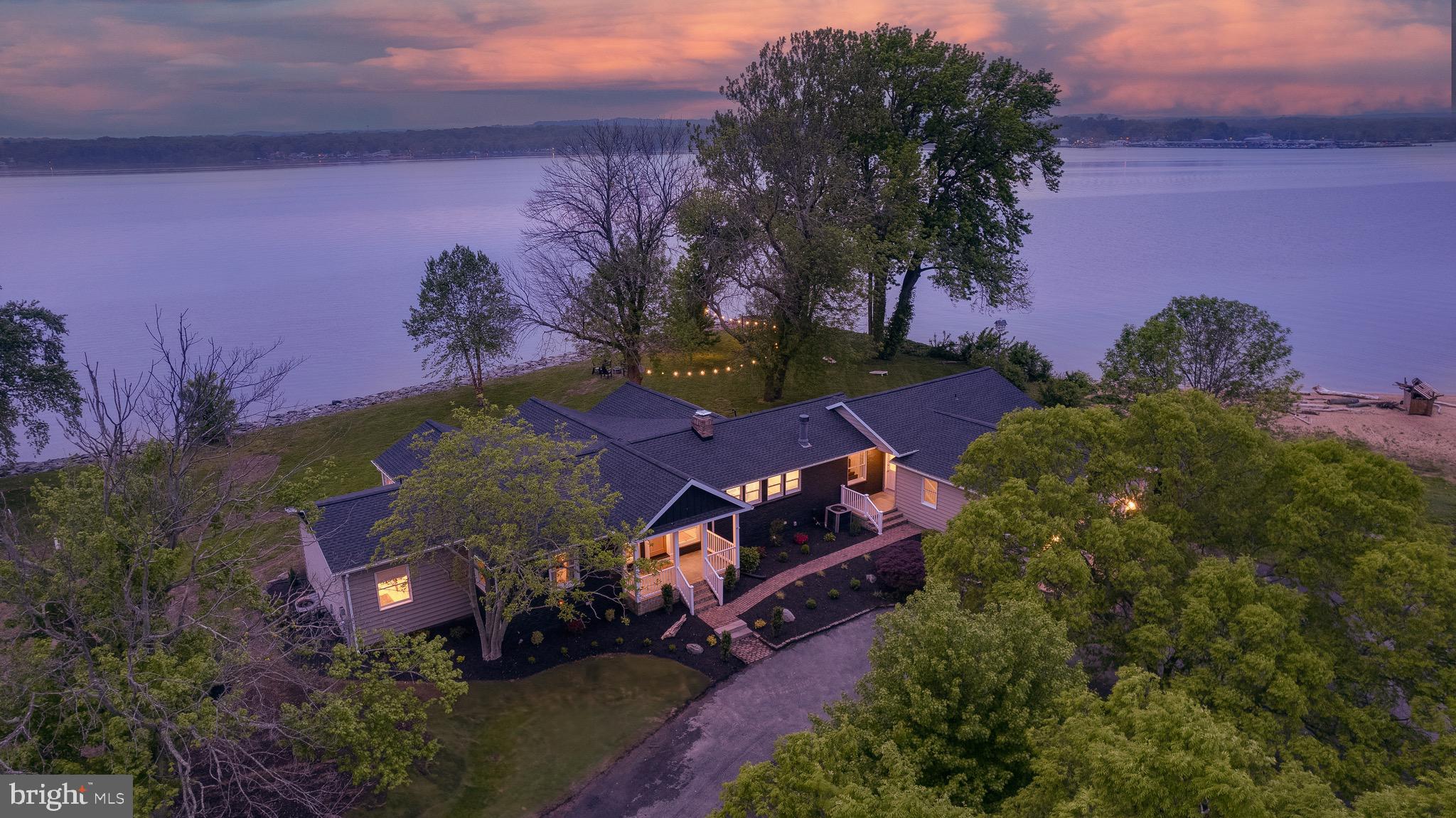 Welcome to your private waterfront paradise on the North East River. This beautifully renovated home stuns from the moment you arrive, offering peace, privacy, and the most amazing water views from nearly avery part of the home.

Inside, vaulted ceilings and expansive windows flood the home with natural light. The gourmet kitchen and spa-inspired bathrooms were designed by Colebrook Designs (see their work on Instagram) with refined attention to detail. Every element is crafted to highlight the home’s most spectacular feature — the water.

The great room welcomes you when you enter the front door, and commands attention with a vaulted ceiling, dramatic fireplace, and show-stopping river views. The adjacent kitchen is a chef’s dream, featuring a high-end stove, wet bar, custom soft-close cabinetry, and an oversized island with seating for four — all framed by wall-to-wall water vistas. A second living area offers a second cozy fireplace for relaxed evenings.

The main-level primary suite is a retreat in itself, with a soaking tub, walk-in shower, and sweeping river views. An additional bedroom and a second full bath complete this wing, perfect for one-floor living.

On the opposite side of the home, you'll find two more guest bedrooms with stunning views, a luxurious full bath, and a 5th bedroom build out as a stylish bunk room with custom build bunk beds — perfect for kids or visitors.

Step outside to take in the beautifully landscaped grounds bursting with color in spring and summer. A spacious cedar deck, private hot tub patio, waterfront fire ring, and a charming swing/daybed area create an outdoor haven. The driveway doubles as a pickleball court, and the adjacent beach makes summer days unforgettable.

Whether you're seeking a full-time dream home or a high-end vacation rental, this property delivers. One of the few on the market of this quality that can actually cash flow as a fully turn key, by right vacation rental, it's a unique opportunity. Homes like this don’t come along often, schedule your private tour today and experience waterfront living at its finest!