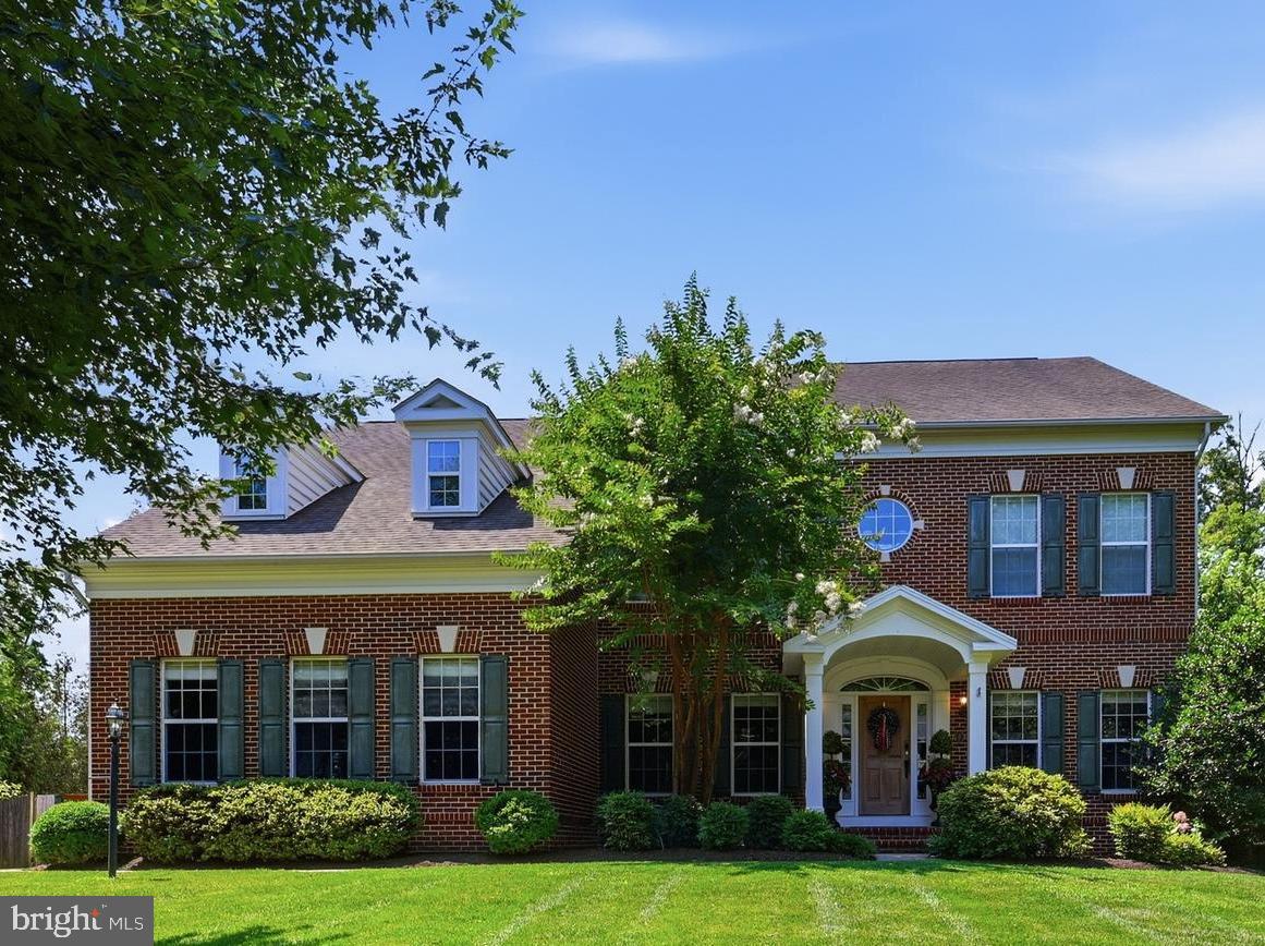 This exceptional Colonial masterfully blends timeless architecture with sophisticated design. A welcoming central foyer opens to elegant living and dining rooms on either side; each defined by striking contemporary columns that pay homage to the area's historic character while embracing a modern aesthetic. From here, the home unfolds into an extraordinary kitchen and family room designed to be the heart of daily living and effortless entertaining. The designer kitchen is a showcase of craftsmanship, pairing crisp white cabinetry with rich mahogany accents for a timeless yet modern aesthetic. A dramatic black, Dekton island anchors the space, while premium appliances including a 6-burner BlueStar gas range, BlueStar double wall ovens, and a Bosch refrigerator, deliver professional-grade performance without sacrificing style. Just beyond, the inviting family room features custom built-ins surrounding a floor-to-ceiling stacked stone electric fireplace, creating a warm and sophisticated gathering space. Just beyond the kitchen, an expansive laundry room offers exceptional versatility. Designed to function as much more than just a laundry room, it features extensive cabinetry, granite countertops, a center island, a built-in workspace, abundant storage, and ample room for crafting and hobbies. Beyond this space, you'll find a private apartment with it's own entrance - ideal for an au pair, long term guests, or extended family. Here, guests will enjoy the comfort and privacy of a self-contained apartment within the home; complete with a full kitchen, inviting living area, private bedroom, and a spacious bathroom featuring both a soaking tub and a walk-in shower.  A stunning staircase leads to the second level, where wide hallways, soaring 9-foot ceilings, and an open landing enhance the home's spacious feel. Four bedrooms are located on this level, including a luxurious primary suite filled with natural light from three large windows. The suite offers a spacious ensuite bath and an impressive 30-foot long dual closet. One of the secondary bedrooms has been thoughtfully transformed into a charming playroom but can easily serve as a bedroom, office, or flex space. The finished lower level is equally impressive, highlighted by a THX-certified home theater complete with a stadium style seating with leather recliners for an immersive cinematic experience. A generous recreation room, full bathroom, exercise room/bonus room, and ample storage complete this exceptional level. Outdoor living is every bit as remarkable as the interior. A large, screened porch just off the kitchen provides the perfect setting for relaxing or dining outdoors insect free, beneath the breeze of an oversized ceiling fan. The covered bluestone patio extends the entertainment possibilities with a fully equipped outdoor kitchen featuring granite bar seating alongside a built-in sink, refrigerator, freezer, flat-top griddle, and grill; featuring premium brands such as Bull, AMG, and Blaze appliances. A meandering bluestone walkway leads to a beautifully illuminated patio centered around a natural stone fire pit, creating an inviting destination for evenings under the stars. Car enthusiasts will appreciate the oversized three-car garage with insulated doors, while the finished bonus space above offers exceptional versatility. Featuring electricity, modern grey flooring, and abundant natural light, this flexible space is ideal for a home office with a private entrance, fitness studio, creative workspace, or private retreat. Additional premium amenities include a whole-house generator and whole-house water filtration system, providing peace of mind and everyday convenience. Over $215,000 has been invested in the home since 2022 (see list of improvements in docs). Meticulously designed and exceptionally appointed, this one-of-a-kind home offers a rare opportunity to enjoy luxury living with spaces thoughtfully crafted for the way you live, entertain, and relax.