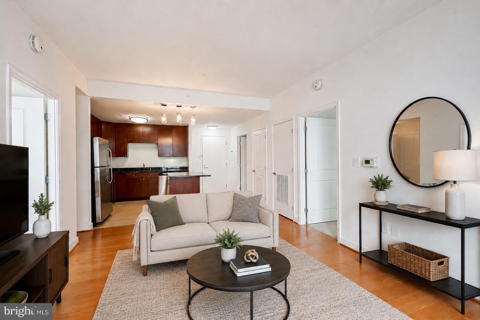 As you walk into this unit, you will immediately be drawn in by the open concept layout. You’ll love that the dining area opens right into your gourmet kitchen. In the kitchen you will find beautiful granite countertops, maple cabinetry and stainless-steel appliances with an abundant amount of cabinet space, perfect for entertaining. The living area is the highlight of this home. With floor to ceiling glass sliding doors and a view of the city and the Capital Wheel.

Two spacious bedrooms are on either side of the condominium, offering you the perfect amount of privacy. As you make your way into the primary bedroom you will notice how large the space is. You will have room for your home office under the bright window or a designated cycling spot. A walk-in closet with built ins will lead you into your spa like bathroom with double sinks and a glass enclosed shower. On the opposite side of the home is the second bedroom. Offering city views without the city noise. This bedroom has a large walk-in closet and a full-sized updated bathroom as well. In addition, there is a stackable washer and dryer in the unit, convenience at its best. The location couldn’t be more centrally located. Close to a variety of shopping and dining and a commuter's dream. Also, comes with an assigned parking space.

And if that wasn't enough, the amenities will put the cherry on the top. What are you waiting for?This home will not last!!