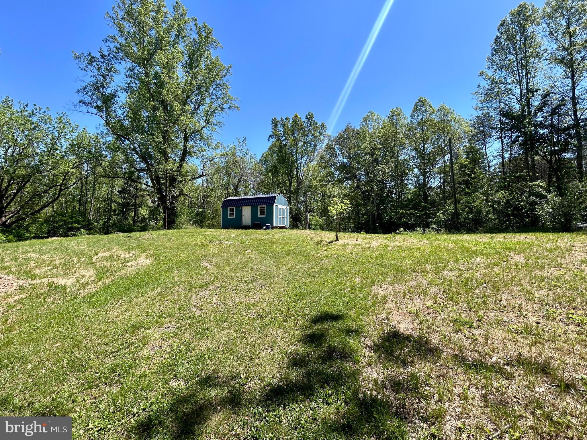 Tucked away at the end of a private lane in Orange County, this 1.53-acre parcel offers the perfect blend of privacy and convenience. The lot is partly open and partly wooded, providing an ideal setting for a future home, weekend retreat, or recreational getaway. Electric and driveway are already onsite, and the property previously housed a mobile home, so a septic system may exist; however, no records are available through VDH. A small shed, thoughtfully converted into a charming getaway space, offers a cozy place to camp or relax while planning and building your dream home. Conveniently located near Lake Anna and within easy reach of Louisa and Orange. Private and a peaceful setting. Seller requests no drive-bys; please schedule showings in advance. Directionals in place to lot, metal "for sale" sign placed at approximate front corner of lot; roadbed extends alongside property line. Small shed is very close to property line.