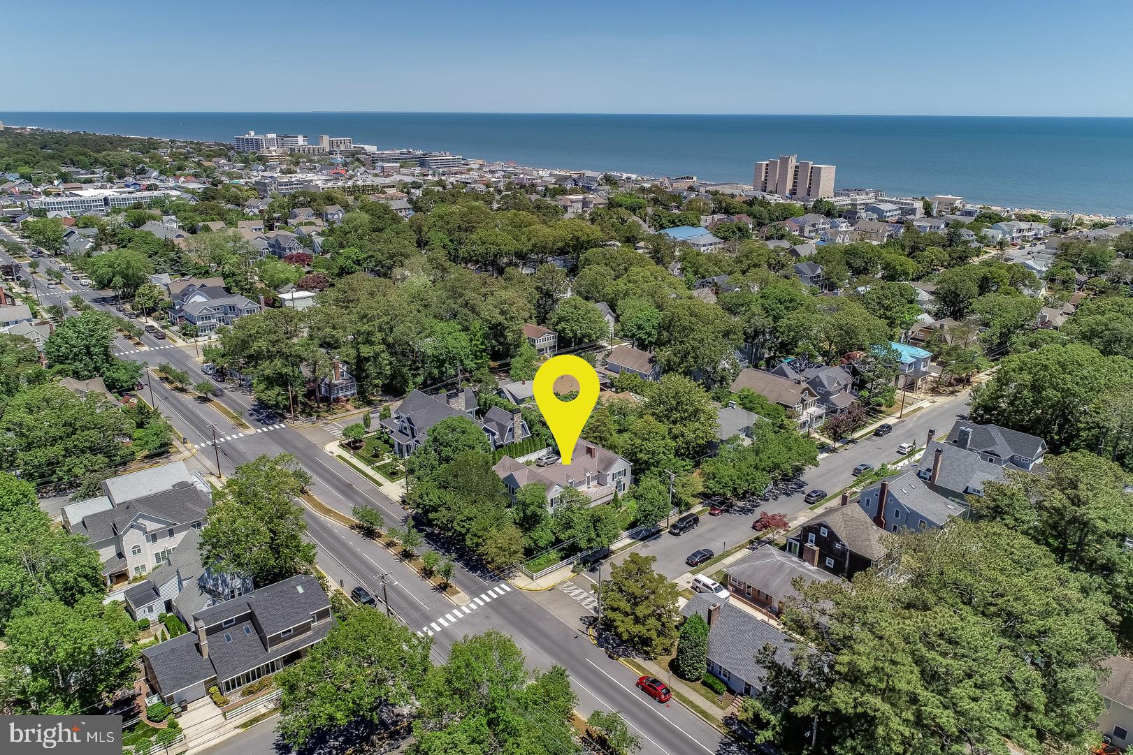 Introducing 125 Stockley Street! This stunning 6 bedroom, 5.5 bath home is situated on a double lot (100' x 100') and only 2 blocks from the beach. Renovated in 2011, this home seamlessly blends coastal cottage charm with modern day amenities. The first floor offers expansive spaces to entertain including a living room with hardwood floors, wood burning fireplace with marble surround, an additional seating area, and formal dining room with crystal chandelier. Step outside onto the spacious hardscape patio which is surrounded by beautiful mature landscaping with irrigation. Adjacent to the dining room is the large gourmet kitchen which boasts granite counters, subway tile backsplash, exposed wood beams, stainless steel appliances, 6-burner gas range, 2 dishwashers, additional ice maker, and warming drawer. Built-in seating creates a cozy eat-in kitchen and the space is completed with a pantry and wet bar with beverage fridge. Finally, a guest suite and a half bath complete the first floor. On the second level you will find a master suite with a spacious private deck, and luxurious bath including vaulted ceilings with tongue and groove wood paneling, tiled shower, double vanity with granite counters and soaking tub. In addition, a guest bedroom with en-suite bath, and 2 bedrooms adjoined by a Jack-and-Jill bathroom. A beautiful separate 2nd floor bedroom is located off the living room and accessed by a spiral staircase. This room features vaulted ceilings with tongue and groove paneling and private bath. Lastly, the 1.5-car garage and unfinished clean and dry basement provide you with an abundance of space for storage. This is a rare opportunity to enjoy Rehoboth Beach charm with all of today's modern luxuries.