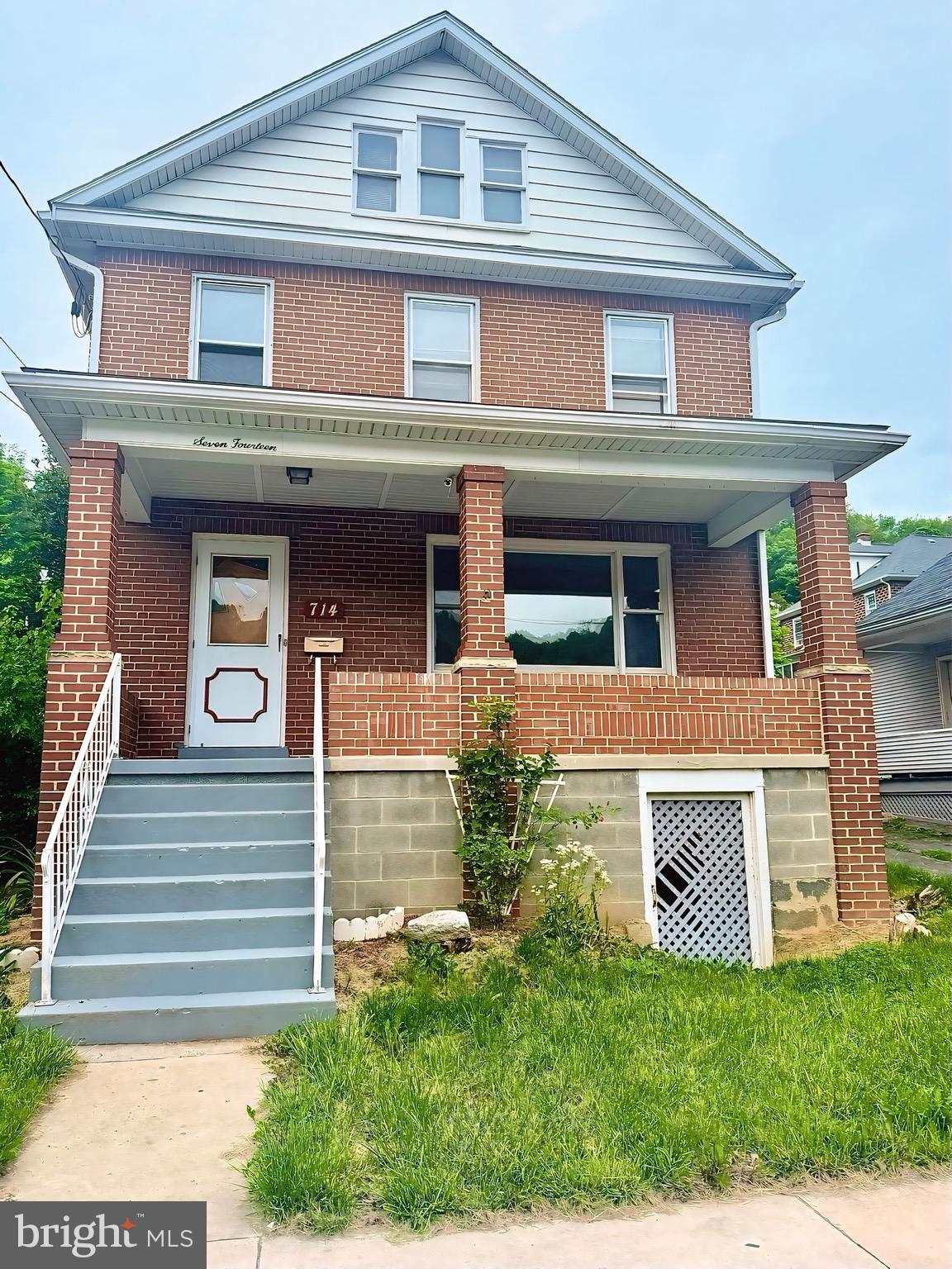 This stately brick 3 bedroom, 2 bathroom home is located on a corner lot with a fully fenced in backyard! Enjoy relaxing on either the upper or lower level covered porches ideal for morning coffee or evening breezes and take in the gorgeous mountainside views. 
Inside, you'll find a bright, kitchen with white cabinetry. There’s even a bonus room perfect for an office, nursery, or guest space! The original woodwork throughout the home adds warmth and character, and the generously sized attic offers even more room for storage or future expansion.
The full basement provides the perfect opportunity to finish for additional living space, and a detached garage adds convenience and extra storage. With its inviting curb appeal and ample space inside and out, this home is full of potential.
Don't miss your chance to make this timeless beauty your own!