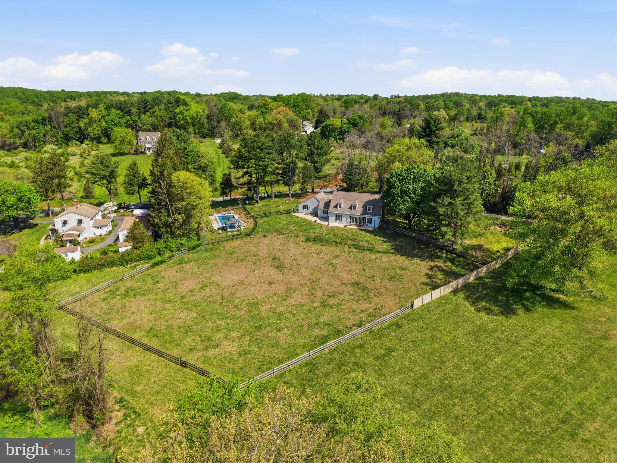 Imagine ending every day with a soft breeze, open land, and a golden sunset- this is what nearly 3 private acres in one of the area's most sought-after locations actually feels like. Minutes from Fair Hill Nature Center, a short drive to Newark's Main Street and the University of Delaware, and an easy shot into Pennsylvania, the setting is rare. But it's the property itself that will stop you in your tracks. Outside, an 18x34 in-ground pool anchors a partially fenced backyard wrapped in mature trees, with a fire pit area, and patio that were made for summer evenings. Inside, the updated main level delivers a cozy country kitchen- granite counters, white cabinets, subway tile backsplash, new plank flooring, and stainless appliances- that flows into a open space eating area and family room with a wood stove and two glass sliders framing stunning rolling hill views. A mud room with vaulted ceilings, wood beams, and custom cabinetry connects to the two-car garage, plus a flexible bonus room works perfectly as a 4th bedroom or home office. Upstairs, the owners suite is anchored by a brick fireplace and barn-style closet doors, with a spa bath featuring a custom tile shower, dual vanity, and soaking tub with brass accents. Two additional bedrooms and a sun-filled loft area- ideal as a reading nook or creative space- round out the upper level. Head down to the basement and you'll find a finished rec room with new carpet and fresh paint, ready to use from day one. A separate unfinished section houses the HVAC and offers serious storage space- the kind that actually keeps the rest of the home clutter-free. Peaceful retreat and entertainer's dream, finally in one place.