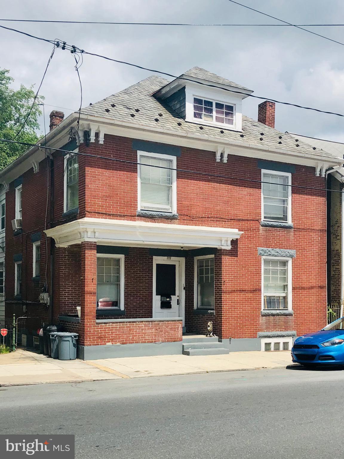 A must-see solid brick house in the Borough of Chambersburg! Well suited for an investment portfolio or an opportunity to live in one unit and rent the other.  This is a duplex with two bedrooms in each apartment and a large backyard that is well maintained and fully fenced. Upper unit has access to the attic that works for additional living space or extra storage and a private balcony with access to backyard from the rear.  First floor unit has access to partially finished and livable basement with lots of storage space and private access to backyard as well. Dual meters for electric. Low utilities on natural gas. There is additional income from the detached 3 unit garage as well.