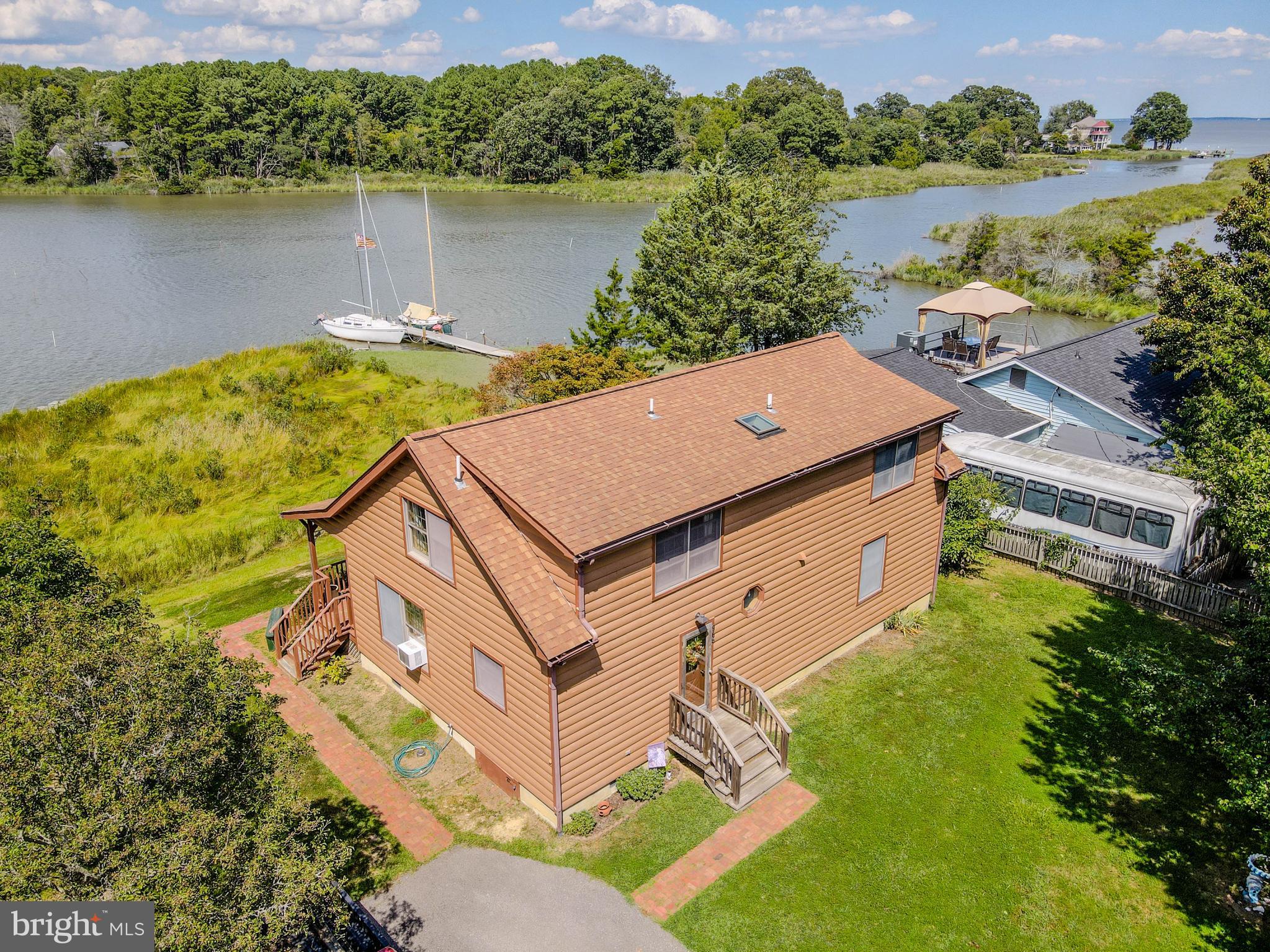Waterfront home on Carrs Creek with access to Chesapeake Bay.  Enjoy broad water views from everywhere on this .34 acre lot in Deale Beach. Within a few minutes of waterfront restaurants, South County Cafe, marinas, shops, library. Also, Black Market Bakers just opened on Deale Churchton Rd! Wonderful location just 45 minutes to downtown Wash D.C., or BWI Airport. 25 minutes to our historic state capital, colonial Annapolis. 
The waterfront lot next door is also offered for sale and features 60' of bulkheaded waterfront, 2 private piers and a boat launching ramp! See the lot listing for 964 Main Street! Purchase both and have it all, plus the investment of a buildable waterfront lot! The home offers a 1st floor bedroom, second floor bedroom  plus a large loft bedroom area upstairs with view of water and living room below. Lots of beautiful natural wood interior, open floor plan. Deale Beach features a community clubhouse on the water, right on Main St