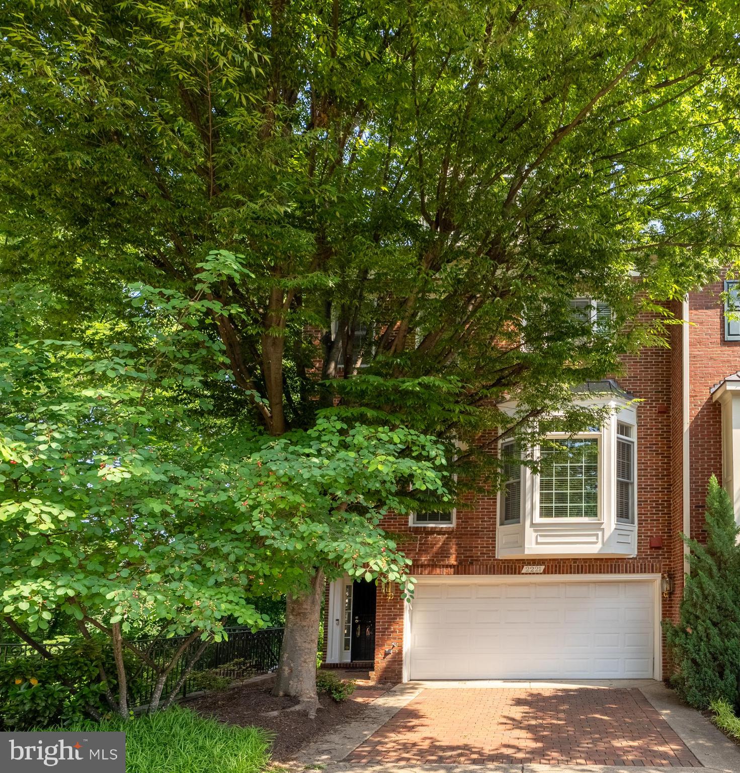 Tucked away in one of Arlington’s best-kept secrets, this stunning end-of-row townhome in Palisades Park offers the rare blend of privacy, space, and convenience, all just moments from the energy of DC. Set along a quiet, tree-lined street, this 4-level residence is a peaceful retreat that overlooks the Potomac River and Georgetown, with serene views enjoyed right from your back deck. Imagine starting your mornings with a cup of coffee in the fresh air, surrounded by nature, while the city slowly stirs just beyond the trees.

Inside, nearly 3,000 square feet of refined living space awaits. The living room is a showstopper; floor-to-ceiling windows framed by timeless arches flood the space with light, while rich hardwood floors and a stately fireplace add warmth and sophistication. Bay windows on the main level offer the perfect nook for reading or enjoying the afternoon sun, while the open-concept layout makes entertaining a dream.

The chef’s kitchen is designed for both beauty and function, featuring a generous breakfast bar, high-end appliances, and ample counter space for preparing meals, hosting dinner parties, or simply enjoying a glass of wine while catching up with a loved one.

Upstairs, the primary suite feels like a private sanctuary. Vaulted ceilings soar above the spacious bedroom, which includes its own fireplace, a private balcony with leafy views, and a massive walk-in closet that’s ready for your dream wardrobe. The ensuite bathroom is equally luxurious, with dual sinks, a soaking tub perfect for unwinding, a separate vanity, and a standing shower that feels like a spa retreat.

With three bedrooms, five bathrooms, and flexible living space spread across four levels, there’s room for it all: guests, a home office, a fitness area, or anything your lifestyle demands.

Location-wise, it’s hard to beat. You’re just moments from Rosslyn, Clarendon, Georgetown, and the heart of DC, yet tucked into a quiet enclave that feels worlds away. Whether it’s a weekend bike ride along the nearby trails, a dinner out in Clarendon, or a quick commute into the city, this home offers a lifestyle that’s as dynamic as it is peaceful.

Palisades Park is the kind of place that once you discover, you never want to leave. And this townhome? It’s where timeless design, thoughtful details, and an unbeatable location come together to create something truly special.