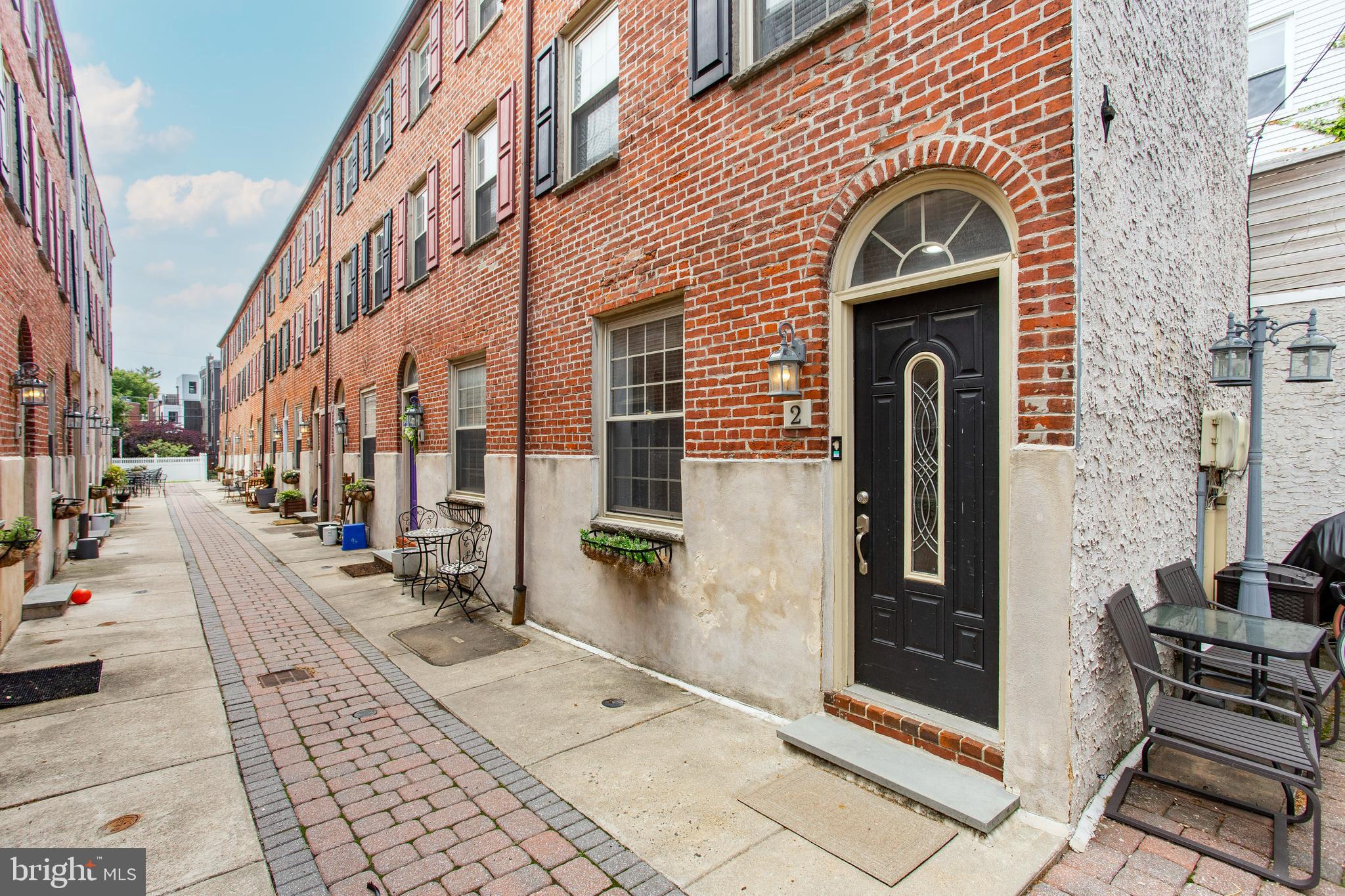Welcome to 525-R Fitzwater Street, #2, a charming 2-bedroom, 1.5-bath Trinity-style home tucked away in a private gated courtyard in the heart of Philadelphia. Offering a rare blend of privacy and city living, this home is quietly situated off the main road while still placing you just steps from the vibrant energy of South Street, renowned restaurants, shopping, entertainment, and local nightlife. As you enter the home, you are welcomed into a bright and inviting living room featuring hardwood floors and a comfortable layout perfect for relaxing or entertaining. Just beyond, the kitchen is thoughtfully designed with granite countertops, stainless steel appliances, ample cabinetry, and a sunlit window above the sink that fills the space with natural light. A convenient powder room completes the main level. The second floor features a spacious bedroom with hardwood flooring and recessed lighting, along with a full bathroom complete with tile flooring and a tub/shower combination with a jacuzzi tub, creating a spa-like retreat. The third level is dedicated to the private primary bedroom, offering hardwood floors, recessed lighting, generous closet space, and a peaceful atmosphere away from the main living areas. The unfinished basement provides additional storage space and includes the home’s utilities along with a washer and dryer for added convenience. This home also offers access to a nearby community grilling area and a convenient gated access point for easy loading and unloading. Located within the highly desirable Meredith School catchment, this property combines comfort, convenience, and an unbeatable city location. With easy access to major roadways, public transportation, and some of Philadelphia’s best dining and entertainment, you do not want to miss the opportunity to make this home your own.