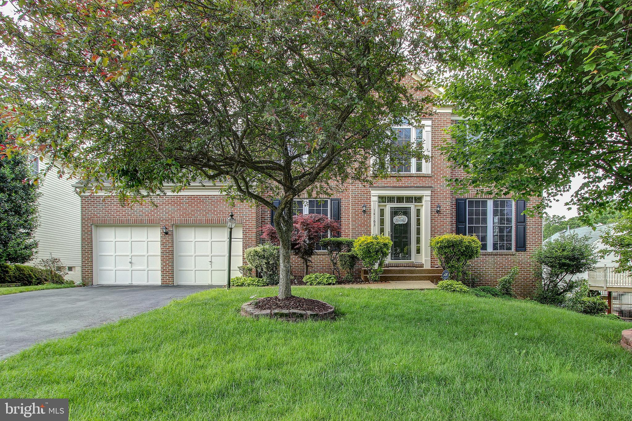 Stunning, Nicely Upgraded, Ultra-Spacious Open-Concept Colonial with Private, Tranquil Back Yard features Brick Front, 9' Ceilings on All 3 Levels, and 4' Extension! Wichesner Newbery Model, Largest in Subdivision. Main Level Features Two Story Foyer, Hardwood Floors, Main Level Office with French Doors, Light-Filled Living Room, Dining Room with Crown Molding, Kitchen with 42" Cabinets, Kitchen Aid SS Appliances Including Wall-Oven with Microwave, French Door with Refrigerator, and Gas Cooktop. Kitchen Leads to Breakfast Area and Family Room with Fireplace, which Opens to an Enclosed Screen Porch Overlooking the Private Back Yard. Floor to Ceiling Windows and Recessed Lights Throughout.  Upper Level Features Owner's Suite with Vaulted Ceilings, Sitting Room, Dual Closets and Lux On-Suite Bath with Dual Vanity, Soaking Tub, Separate Shower, and Water Closet. Upper Level Includes Three Additional Generously Sized Bedrooms and Hall Bath with Dual Vanity.Walkout Lower Level with Daylight Windows Features a Large Rec Area, Full Bath, Two Additional Dens/Offices/Guest Rooms, Recessed Lights, and Walks out to Covered Patio with Retractable Overhang and Relaxing Oasis of a Back Yard.Updates Include Refinished Wood Floors, Covered Deck (35K), Bridge in Back Yard, Patio with Retractable Awning, New Paint Throughout, Carpet in Lower Level and More.  Low HOA Fee Includes the ClubHouse, Pools, Tennis and Basketball Court. Beautiful Park by the Lake and Trails are Perfect for the Summer. HVAC is Dual-Zone for added comfort. Owner prefer Rent Back if buyer has that flexibility.