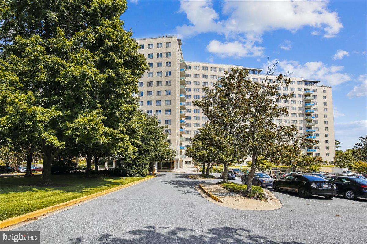 Enjoy effortless living in this amenity-rich building with this spacious, sun-drenched two-bedroom, two-bath corner residence offering over 1,200 square feet of beautifully designed living space, a wonderful balcony, and two parking spaces. Bathed in natural light, this inviting home enjoys windows on two sides and a spacious northwest-facing balcony with beautiful sunset views. The well-designed floor plan features parquet wood floors, recessed lighting in the living room, dining room, and kitchen, and an abundance of storage, including multiple walk-in closets.
The spacious living and dining rooms are enhanced by wood flooring, crown molding, recessed lighting, and expansive windows. The dining room opens to the functional kitchen, which features a stainless-steel microwave and dishwasher, gas cooktop, wall oven, and ample prep space.
The bright primary bedroom offers a ceiling fan, a walk-in closet, and a private bathroom with updated flooring, an updated vanity, and a niche with shelving. The second bedroom features a Murphy bed with abundant built-in storage, making it ideal for guests, a home office, or both. The home is complete with a second full bathroom and a large walk-in foyer closet. One garage parking space (94L1) conveys, and an additional surface parking space is included.
Residents enjoy an amenity-rich lifestyle with 24-hour concierge service, overnight security (10 p.m.–6 a.m.), an outdoor pool, tennis courts, an exercise room, a rooftop lounge and event space, a garden room with a kitchen, bicycle storage, laundry facilities, a mailroom, and active social and environmental committees. The beautifully landscaped courtyard, complete with walking paths, offers a peaceful retreat. The condo fee includes all utilities and amenities, providing exceptional value.
Ideally located near the Grosvenor–Strathmore Metro, NIH, Strathmore Music Center, Rockville Pike, shopping, dining, and entertainment, with convenient access to I-495 and I-270. A wonderful opportunity to own a light-filled home with exceptional amenities in a prime North Bethesda location.