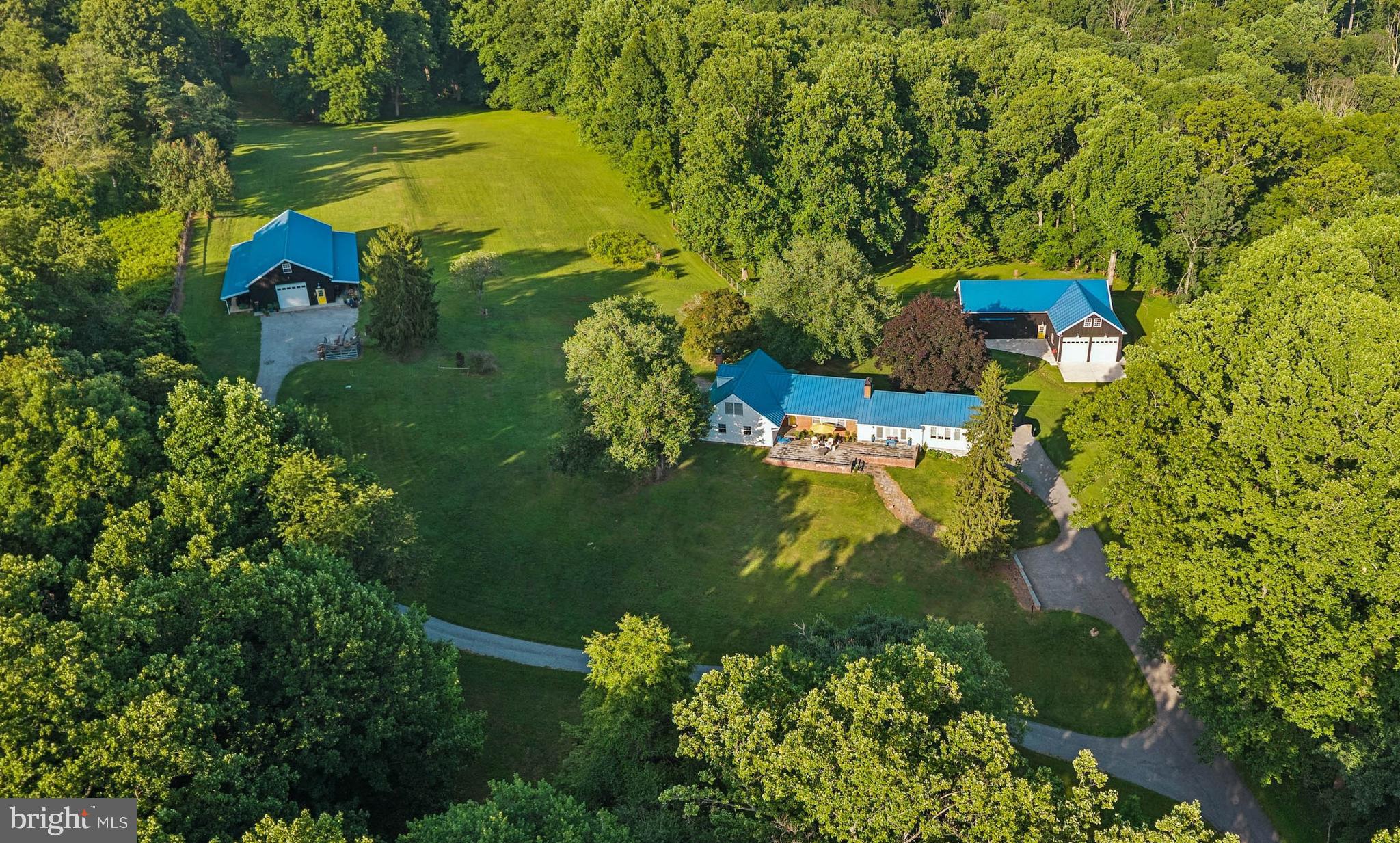 ESSENCE
Live authentically. Sapphira Farm - Phoenix. Take the road less traveled. A nestled 14 acre perch surrounded by woodland, teaming with wildlife. Distinctive blue standing-seam roofs catch the light. Cheerful pop yellow doors greet you, inviting you in. The doors electrify against the Icelandic aesthetic black barns. Two amazing Amish-built barns punctuate the landscape. Stained in a traditional linseed oil and pine tar finish offering a plethora of possibilities: the ultimate collector space, art studio, horse stalls, a climate-controlled office/lounge awaiting your vision. Propane, well, and septic systems are separately run to support the upper barn's independent use. The grounds invite exploration... a fenced dog pasture bordered by woods, a nine-hole disc golf course with regulation baskets. Embrace the farm to table lifestyle. The sellers are beekeepers with vibrant herb and veg raised beds. Whole house lovingly renovated. Vaulted ceilings crown the sun-washed living spaces, where a dual-sided fireplace connects the sitting room and sunroom. Walls of windows frame your compound and scenic vistas in the distance. A second wood-burning fireplace anchors the gathering space. Newly planted hillside of 150 native Maryland trees (redbud, loblolly pine, black locust, bald cypress) planted in partnership with the MD Forestry Service, ensuring the landscape only grows richer with time. A rare offering. Feel worlds away while being proximate to conveniences. Generator transfer switch. Upper barn 50'x70', 11' high doors, L barn 40'x28' and 54'x28', 12' high doors. Xfinity internet. See sellers amenity list for details. Cultivate your existence. The art of uniting human and home.

LOCAL FLAVOR AND PROVISIONS
John Brown Store and Wegmans. Favorite local dining at The Milton Inn, The Oregon Grill, The Butler Cabin, and The Filling Station. An exit north offers Graul's Market along with Casa Mia’s, Manor Tavern, Woodfire Kitchen and The Creamery Connection. Tap into local breweries, such as Inverness Brewing, Farmacy Brewing and Big Truck Farm Brewery.

OUTINGS AND LEISURES
Explore the NCR Trail. A 21-mile flat, crushed-stone trail open to hikers, bikers, and horses, it runs along the scenic Gunpowder Falls river. Go tubing on the Gunpowder River. Enjoy Ladew Topiary Gardens... these gardens are 22 acres of spectacular, award-winning gardens, more than 100 remarkable topiaries, a mile-long Nature Walk, and native Butterfly House. Explore The Manor Mill, a pre-revolutionary grist mill that now houses a wide variety of art and entertainment events. Tee off at Hunt Valley Country Club Golf Course or Pine Ridge Golf Course. Or visit The National Lacrosse Hall of Fame and Museum which honors the history and legends in the sport. 

PROXIMITY
Zippy access to the I-83 on ramp, about 19 minutes to Hunt Valley, and about 23 minutes to Towson. 60 minutes to BWI and 32 minutes to Penn Station.

REGION
Established in the 1700s, the village was once an old mill town. It notably served as a filming location for scenes in John Waters' 1972 film Pink Flamingos.