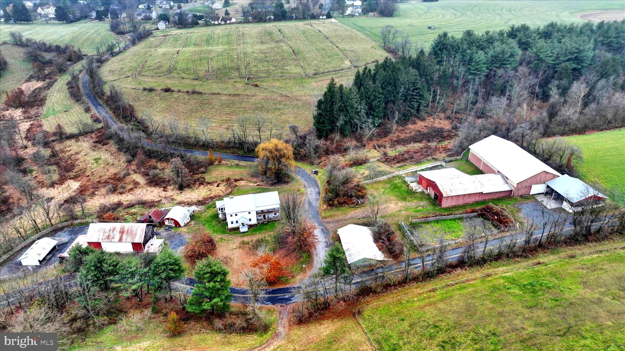 Dandelion Farm - Your 69acre Equestrian Dream Home Awaits.  -The former Dandelion Farm Equestrian Center sits on 69 acres and centers around a beautiful 4016 sq ft farmhouse that dates all the way back to 1850. It's been lovingly updated over the years keeping all the original charm while giving you the modern comforts you need. When you walk through the front door you will immediately see where  the old meets the new. The foyer features repurposed wood flooring that was salvaged right from the original second floor. The old west wing is now an enormous living room with exposed wall beams. This will be the perfect party spot complete with a slate-top wet bar and durable LVP flooring. The cozy sitting room flanks the foyer to the left upon entry and features a working brick fireplace with raised hearth. The floors are the original wide wood planks,  The large, updated kitchen  spans the rear east side of the home and features modern stainless steel appliances, plenty of cabinets and counter space.  The dining area also has a coal stove for supplemental heat. There is also a renovated half bath on the first floor.  Upstairs there are 5 BEDROOMS AND 4 FULL BATHS ! The primary bedroom has an attached  bathroom with newly installed shower and LVP flooring.  There is also a second bedroom that features an attached bath and then 2 more hallway bathrooms. And if you need more room the third floor has been partially finished and could be another bedroom, studio or office. There is also a room that has roughed in plumbing for a 5th bathroom that has not been completed. Now for the Farm :  This property is an equestrian's dream   with everything you need to run a professional operation.  The Main barn features 18 stalls, a tack room, a wash rack a half-bath and an impressive 100x60 foot indoor arena.  There is also an additional outdoor training arena across the road, a second smaller barn  ( both have water ) a large 2 story machine shop, tractor shed, a bank barn and a milk house. Now for the Land :  The pastures are set up with a frost free water pumping system for irrigation and there is electric fencing installed and just waiting to be activated. There is so much more here to see - call for your appointment and see this beautiful farm for yourself !