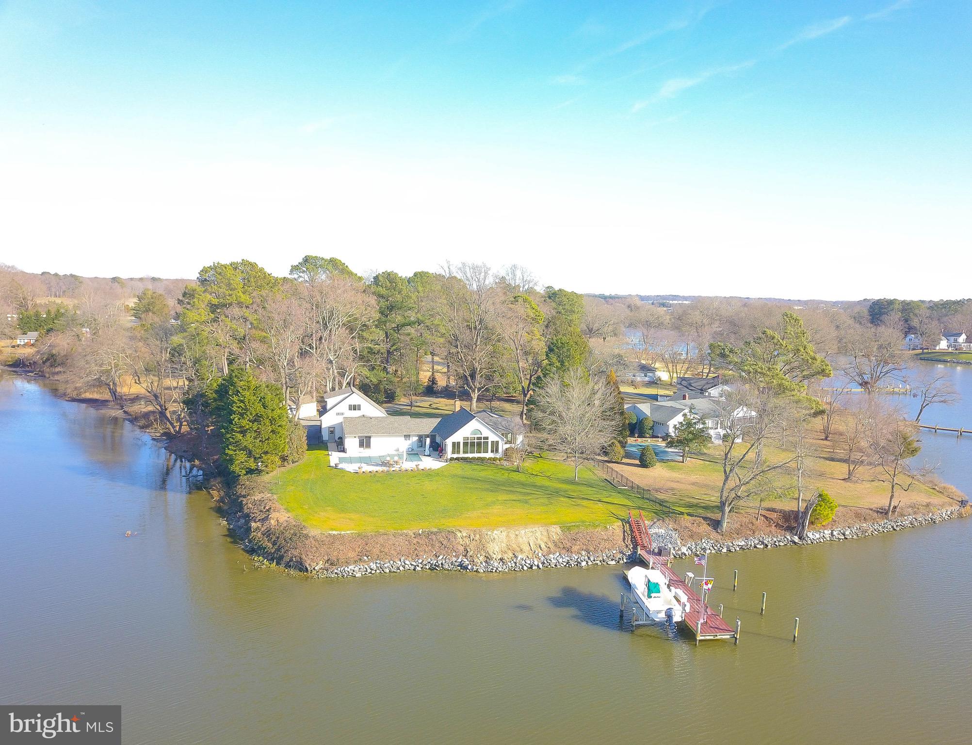Welcome to Blue Heron Cove on Glebe Creek.  This offering has it everything on a buyers list!  Offered now for the first time, family owned since it was built in 1958.  Meticulously maintained throughout the years and improved with modern features.  Amazing 1.25 acre waterfront point with 4.5 MLW , dockage, 2 slips, 5 T. boat lift.    Quick sail to Miles River.    Waterside  gunnite  inground  pool.   Situated just minutes from Easton and St Michaels amenities.  Boasting 3488 square feet of panoramic views of Glebe Creek and Western exposure for the most stunningly dramatic sunsets.   This house is designed for entertaining with a vaulted ceiling great room, kitchen with island and views, views, views from every room! Split floorplan with primary ensuite bedroom poolside and 2 guest bedrooms and full bath on opposite side of house.   Large water view room above the garage is multi-purpose, currently used as office. Enjoy great storage with a partial basement.  2 car attached garage and additional shed.  New roof and skylights 11/2023