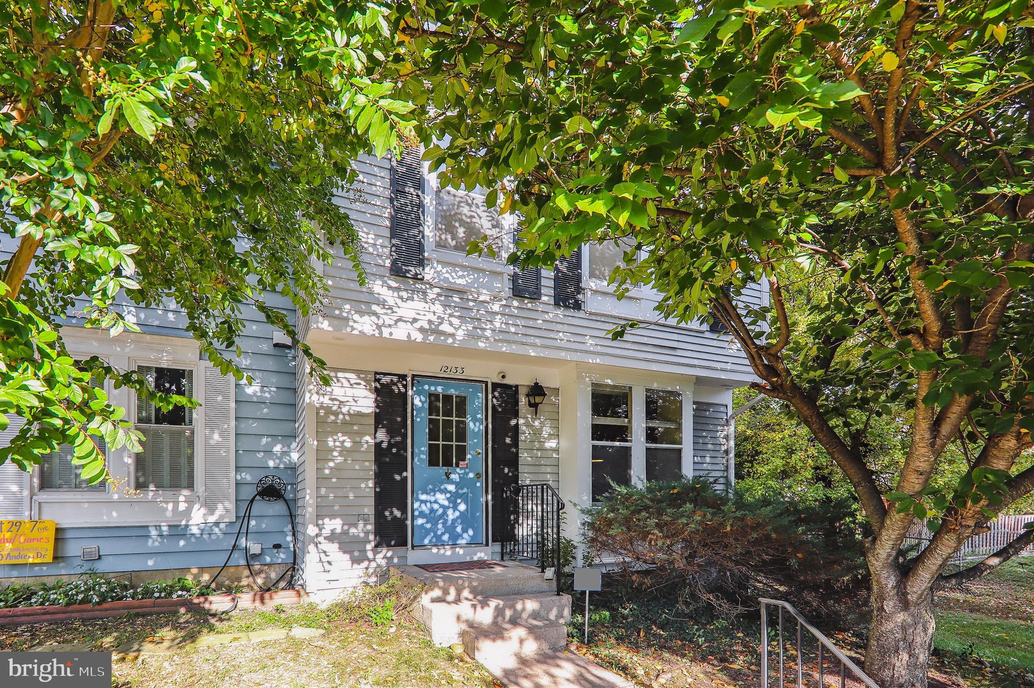 HUGE $20K PRICE REDUCTION!! COME & SEE!! Fabulous commuter location, convenient to DC, Baltimore, NASA, University of MD. Tree-shaded end-unit townhome with deck located at end of quiet court, with 2 assigned parking spaces right in front! Spacious renovated table space kitchen features granite countertops, solid wood soft-close cabinets and drawers, with extra cabinets and counter space installed. Additional amenities are under-cabinet lighting, stone tile backsplash, and custom window shades that open from top *OR* bottom. Enjoy peaceful green views through the kitchen pass-through as you prepare a meal or clean up. Living room offers a Thompson Creek slider to the deck backing to common area. Two large bedrooms upstairs have remote-controlled ceiling fans with lights, and most of the upper level windows are by Thompson Creek. Full bathroom with stylish vessel sink connects to primary bedroom and hall, and both bedrooms are large and have enough closet space. Downstairs the rec room offers a cozy wood-burning fireplace, an outside exit, and lots of storage space. The large laundry room features motion detector lights so you don't have to fumble for a switch with an armload of laundry and also has plenty of room for storage. The hardwired 2-camera security system backing up to DVR conveys. Extra insulation and a heat shield have been added in the attic, and shade trees front and back lower your cooling costs. LOW HOA FEE. Home warranty of buyer's choice included. Whether it's coffee on the deck or hot chocolate in front of the fireplace, this freshly painted space with new carpet throughout is ready to welcome you home!
