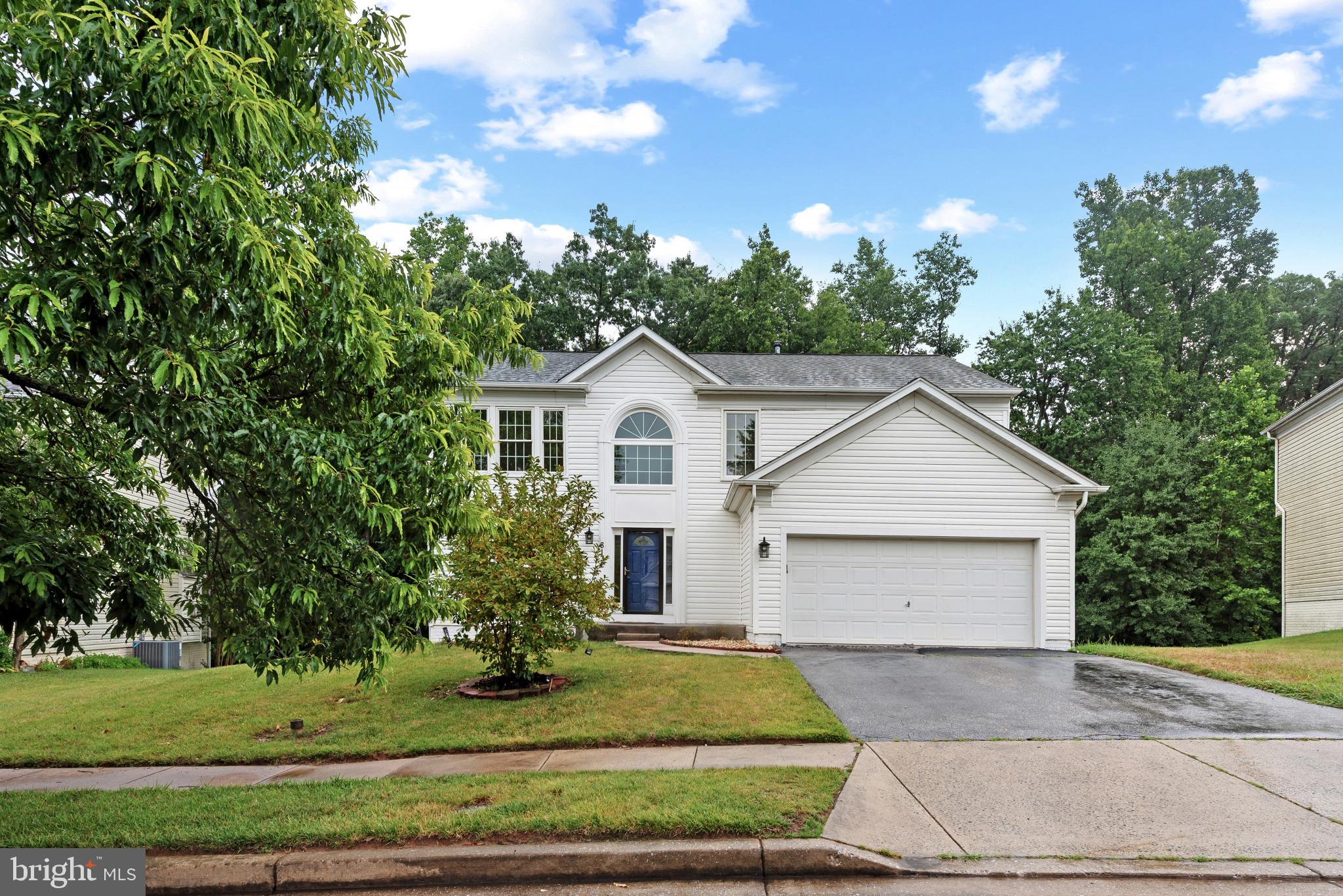 Beautifully renovated transitional-style Colonial residence offering 3 bedrooms, 3 full bathrooms, 1 half bathroom, and 3,268 finished square feet in picturesque Fielder. A private driveway leading to a 2-car garage, a crisp white façade, and a charming blue front door create a warm first impression, welcoming you into a bright and thoughtfully updated interior, including fresh paint and updated flooring throughout. // Rich hardwood flooring extends throughout the traditional main level, beginning in the impressive two-story foyer and continuing into the formal living room, where oversized windows fill the space with natural light. The adjoining formal dining room is accented by elegant wainscoting and a graceful bay window, creating the perfect setting for both everyday meals and special gatherings. // The beautifully updated eat-in kitchen is designed for both functionality and entertaining, featuring a center island with breakfast bar seating, upgraded countertops, stainless steel appliances, and abundant cabinetry. An inviting breakfast area with direct deck access provides the ideal spot for casual dining. Just beyond, the spacious family room is defined by a guardrail overlook and anchored by a cozy fireplace, creating a comfortable gathering space. A conveniently located powder room completes the main level. // Upstairs, newly added carpet flows throughout a versatile loft that offers flexible living space ideal for a sitting area or home office and could potentially be converted into a fourth bedroom with future modifications, as well as in three generously sized bedrooms. The spacious owner's suite serves as a relaxing retreat with a walk-in closet and a private ensuite bathroom featuring newly installed LVP, a corner Roman soaking tub, dual-sink vanity, glass-enclosed shower, and a private water closet. One of the secondary bedrooms enjoys dual access to the hall bathroom, providing a convenient semi-private ensuite layout. This level also includes a second full bathroom and a centrally located laundry room for added convenience. // Newly installed Luxury vinyl plank flooring spans the finished walk-out lower level, where a spacious recreation room offers endless possibilities for entertaining, recreation, or relaxation. A versatile bonus room with dual access to the third full bathroom provides additional flexible space to accommodate guests, a home gym, or a private office. // Outdoor living is equally impressive with an elevated deck that steps down to an expansive open-air patio and an adjacent covered patio framed by a retaining wall. Backed by mature trees, the private backyard offers a peaceful setting for outdoor dining and entertaining. // Select photos have been virtually staged for illustrative purposes only.