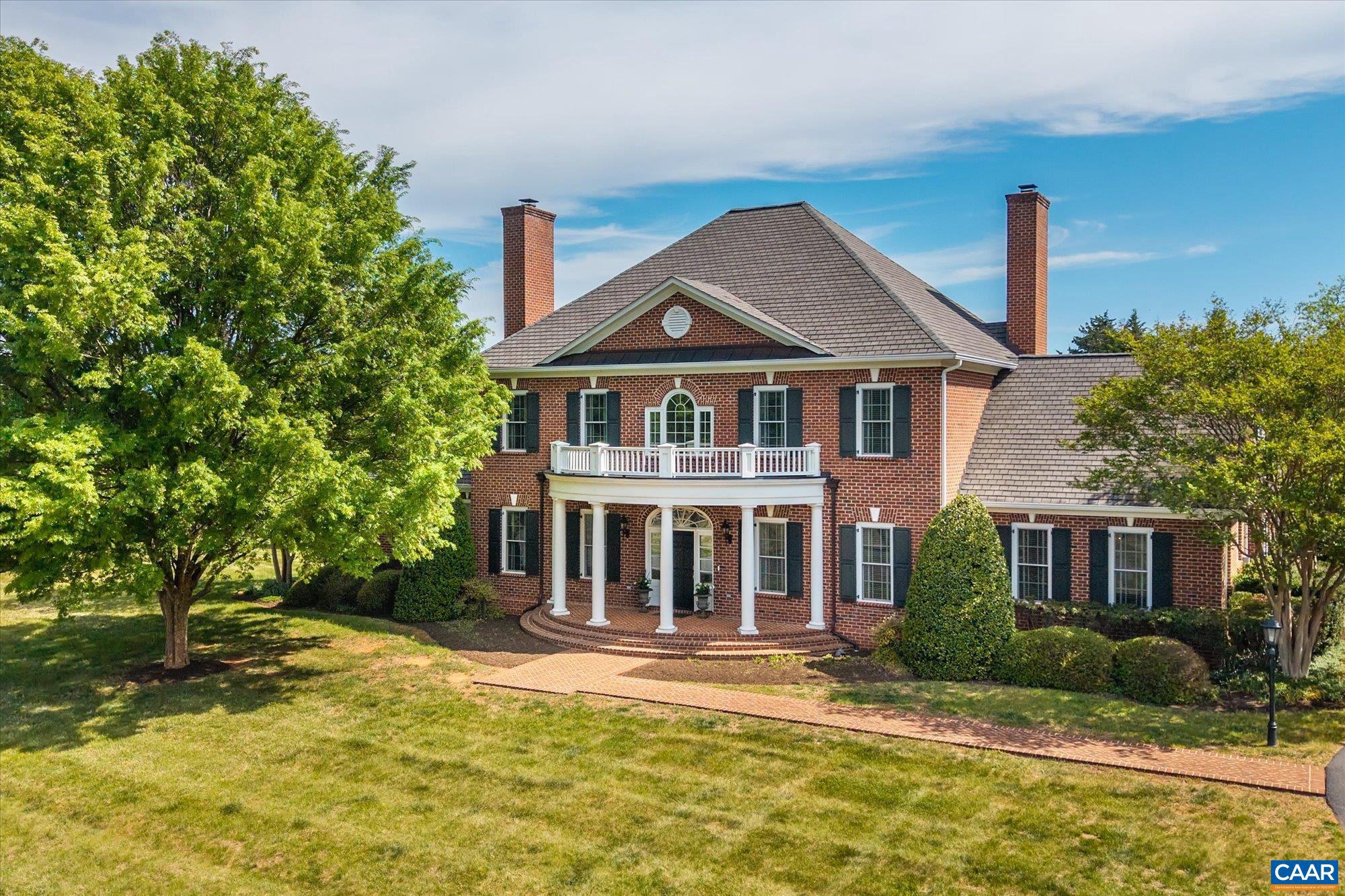 A stately residence in a coveted Ivy location features an exceptional floor plan that includes a first-floor primary suite and allows for seamless connectivity throughout thoughtfully designed rooms. The well-appointed kitchen is tailored for both everyday living and entertaining, featuring high-end appliances, a gas range, two dishwashers, a wet bar, a breakfast bar, and a sunlit breakfast room. Formal living and dining rooms offer timeless entertaining spaces, while a handsome study creates an ideal work-from-home setting. The inviting family room, anchored by a fireplace, opens to a delightful screened porch, perfect for relaxing or gathering. Upstairs, three generously sized bedrooms each feature ensuite bathrooms, while a fifth bedroom offers flexibility as a nursery or second office. A spacious recreation room above the three-car garage adds versatility. A massive unfinished basement with roughed-in bedroom, bathroom, and fireplace allows room for expansion. This home has it all, from a welcoming marble foyer with curved staircase to two laundry rooms and a mudroom. Enjoy Blue Ridge views from the front yard in this supremely convenient, pedestrian-friendly, picturesque neighborhood.,Painted Cabinets,Wood Cabinets,Fireplace in Family Room,Fireplace in Living Room