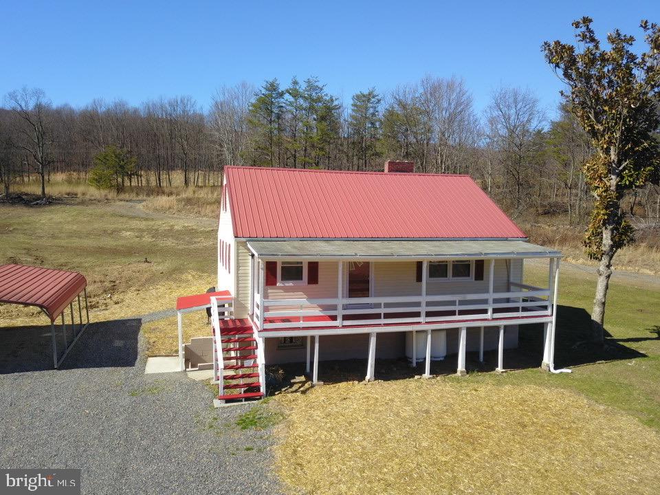 Rawlings, MD – Totally Restored & Remodeled Family Farmhouse Perched on 18+ Flat Gentle Rolling Acres w high Traffic Volume on US Rte #220. Large Front Covered Porch leads to roomy Interior which includes Eat-in Kitchen w All New Appliances, Granite Countertops, & Ceramic Tile Floors. Living Room offers New Laminated H-Wood Floors, (2) Bedrooms & Full Bath Shower/Tub Combo.  2 Bedrooms and Full Bath on 2nd Flr.  Full Unfinished Basement with Exterior Access. Other amenities: Large Detached Garage (TLC), Carport, Workshop, 2  Front Lots with Water/Sewer and Underground Electric, Vinyl Siding, Oil, Propane & Electric BB Heat.  This is a Multiple Use Property with Excellent Potential for Commercial Use.  Call for more info, you won’t Regret it!
