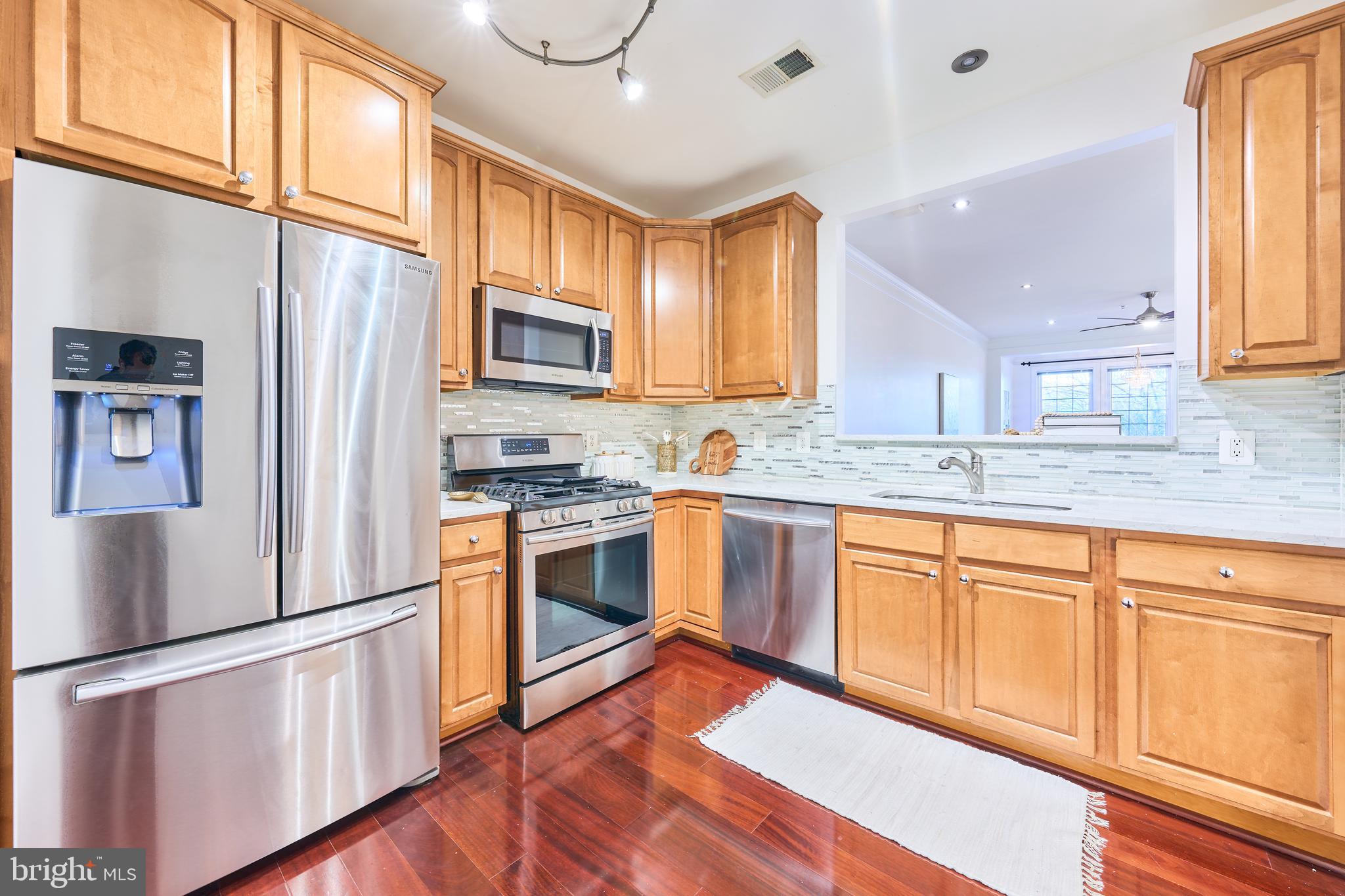 Over 1,600 sq. ft. of refined living in a vibrant 55+ community. Recently updated with luxury Brazilian cherry hardwood floors and recessed lighting in the living area. Newly painted, and new wall-to-wall plush/firm carpeting in the bedrooms. The home features an elegant dining room with a columned entry and detailed moldings, a spacious living room, and a bright sunroom large enough for a baby grand piano. The primary suite offers a generous bedroom, three closets, and a bath with both a soaking tub and a separate shower. The versatile second bedroom can serve as a guest room or den. Condo fees include full access to Ashburn Village amenities—Sports Pavilion, pools, tennis, and more.