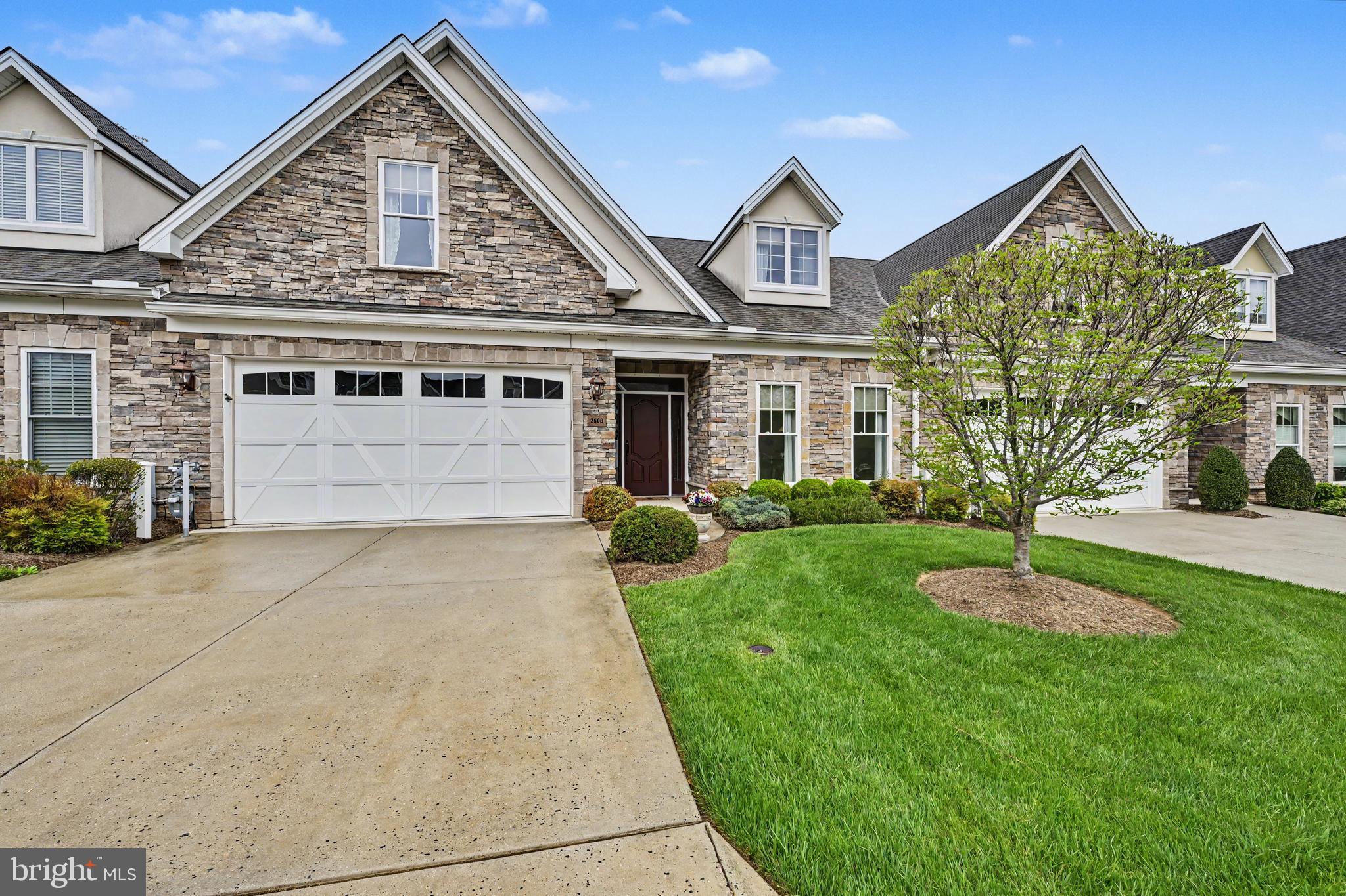 55+ Villa style in desirable Bentley Ridge  -  MAIN FLOOR PRIMARY BEDROOM  +  LUXURY BATH  +  MAIN FLOOR LAUNDRY  +  2 CAR GARAGE  +  YARD MAINTENANCE  for a carefree lifestyle.  You'll love the liveability of this open floor plan,  which still offers 'big house' features like a formal foyer,  formal dining room,  first floor den/office,  breakfast room,  upstairs den and 9 foot ceilings.   The first floor primary  bedroom suite features a full bath with walk-in shower & seating,  double vanity & large walk-in closet,  while 2 upstairs bedrooms are graciously sized and sport their own sitting room.   The large living room with gas fireplace opens to the gourmet kitchen with top of the line appliances,   gorgeous 42" cherry cabinetry and an island big enough for grandchildren and guests!   The breakfast room overlooks a nicely sized back patio and is the perfect place to enjoy your morning coffee or spread out with a big craft project.  The 1st floor laundry opens to a 2 car garage with plenty of extra room for storage.   There's also a large  'hidden' parking lot with plenty of overflow parking for guests - have a look, it's just across from the gazebo and green space.   And speaking of green space, the yards and open spaces are beautifully maintained - you don't have to lift a finger!  You're just five minutes to Wegmans, shops and dining at Boulevard at Box Hill.