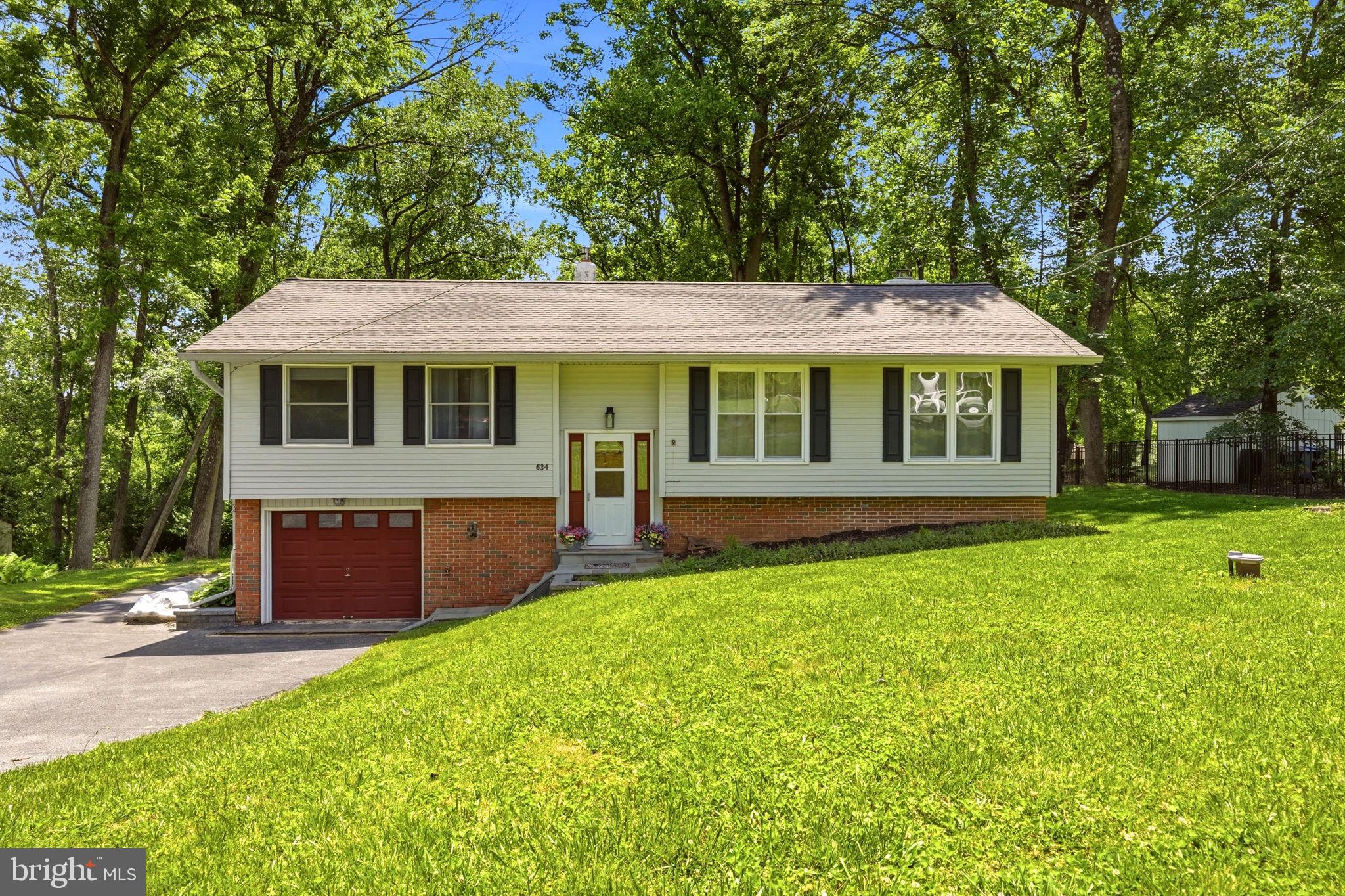 Welcome to this charming bi-level home located in the highly sought-after Unionville-Chadds Ford School District! Nestled on a private, wooded 0.81-acre lot, this 3-bedroom, 2-bathroom residence offers a peaceful setting with plenty of space both inside and out.
Step inside to find new luxury vinyl plank flooring flowing throughout the living room, dining room, and kitchen. The sun-filled living room features a ceiling fan, large windows that fill the space with natural light, and cabinetry for additional storage. The open layout seamlessly connects the living room to the dining area and kitchen, creating an ideal space for everyday living and entertaining.
The kitchen is equipped with granite countertops, stainless steel appliances, a ceiling fan with light, and a sliding glass door leading to an expansive Trex deck overlooking the tranquil backyard and wooded surroundings. Stairs from the deck provide easy access to the rear yard, making outdoor entertaining and everyday enjoyment of the property a breeze.
Down the hall, you'll find three comfortable bedrooms. One bedroom features vinyl flooring, while the other two are carpeted and share a hall bathroom with a tub/shower combination.
The fully finished lower level provides exceptional additional living space and is perfect for entertaining. Highlights include a stunning brick fireplace in the den, multiple flex rooms ideal for a home office, gym, playroom, or guest space, a full bathroom, laundry area, and convenient access to the attached 1-car garage.
Recent updates provide added peace of mind, including a new roof installed in 2025, HVAC system replaced in 2022, and a hot water heater installed in 2022.
Outdoor enthusiasts will appreciate being just minutes from the hiking trails and scenic beauty of ChesLen Preserve as well as the canoeing, kayaking, ziplining , and other outdoor adventures offered by Brandywine Outfitters. Offering the perfect combination of comfort, functionality, modern updates, and convenient access to recreation, this home is one you won't want to miss!