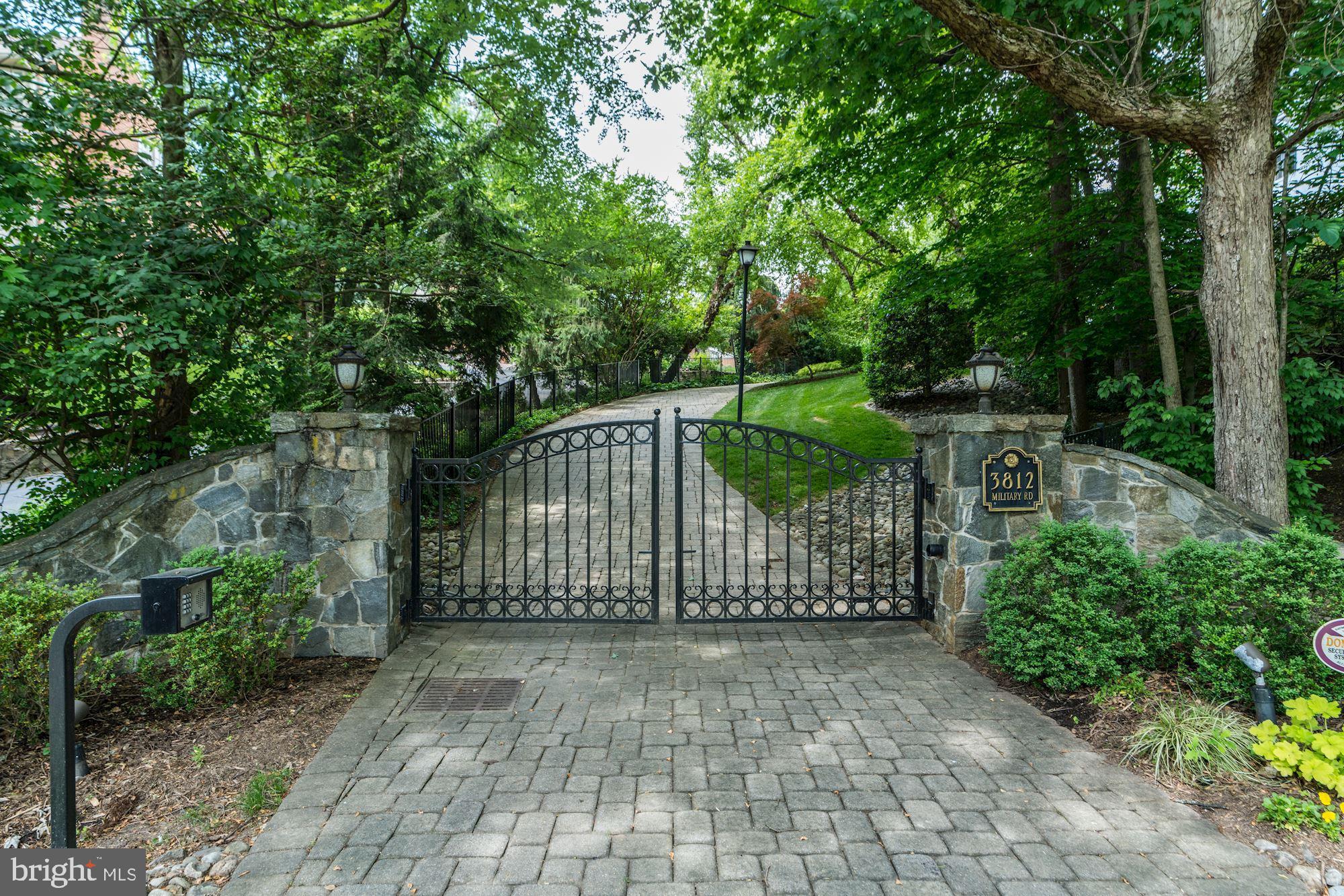 Your most important real estate appointment in years may be to see 3812  Military Road for many reasons. You will find a home intoned with the most harmonious design for elegant living combined with a shoes-off relaxin  atmosphere that is not duplicated in any home I have seen. Originally built in 1932 this Stone Colonial home has been masterfully redesigned by one of Arlington s most respected builders. Upon arrival the automatic security gate will open to a winding, paved drive extending through the property. The main level has tall ceilings, hardwood flooring, and extensive custom mill work throughout. This home is absolutely stunning! A true gourmet kitchen is found in the rear of the home and opens to a two-story family room with a gas stone fireplace and French doors that open to a most charming rear yard.  A must see is the custom Cherry paneled library. One of the owners  favorite features of this home are the French doors that open to the outside throughout the main level. The upper level Owners suite is definitely noteworthy. An architectural wall of raised paneling separates the sleeping area from the sitting area, creating a luxurious and calm escape. Floor to ceiling customized wall storage, plus a generous walk-in closet complete the Owner s suite. Transport yourself to Europe when entering the custom marble spa bath with a separate over-sized shower, soaking tub, double vanities, and custom cabinetry. The second bedroom on this level is a lovely en suite bedroom adjacent to a second family room with 3 sets of French doors that open to and overlook the family room below. The laundry is conveniently located on this level. The 2nd upper level offers 3 additional bedrooms with en suite baths and a sitting room. Heading to the basement you will find a large media room, exercise room, if you wish, and storage galore. There is a two car side-load garage, plus a 2 car detached garage.  A private, wooded, main approach opens to a beautifully landscaped flat back yard with extensive patios and a screened Gazebo where one can watch TV and enjoy the garden views.  Add to this, the appreciating asset of a build-ready lot of approximately 13,000 sq. feet. Savor the Fine Taste of Elegant living at 3812 Military Road.