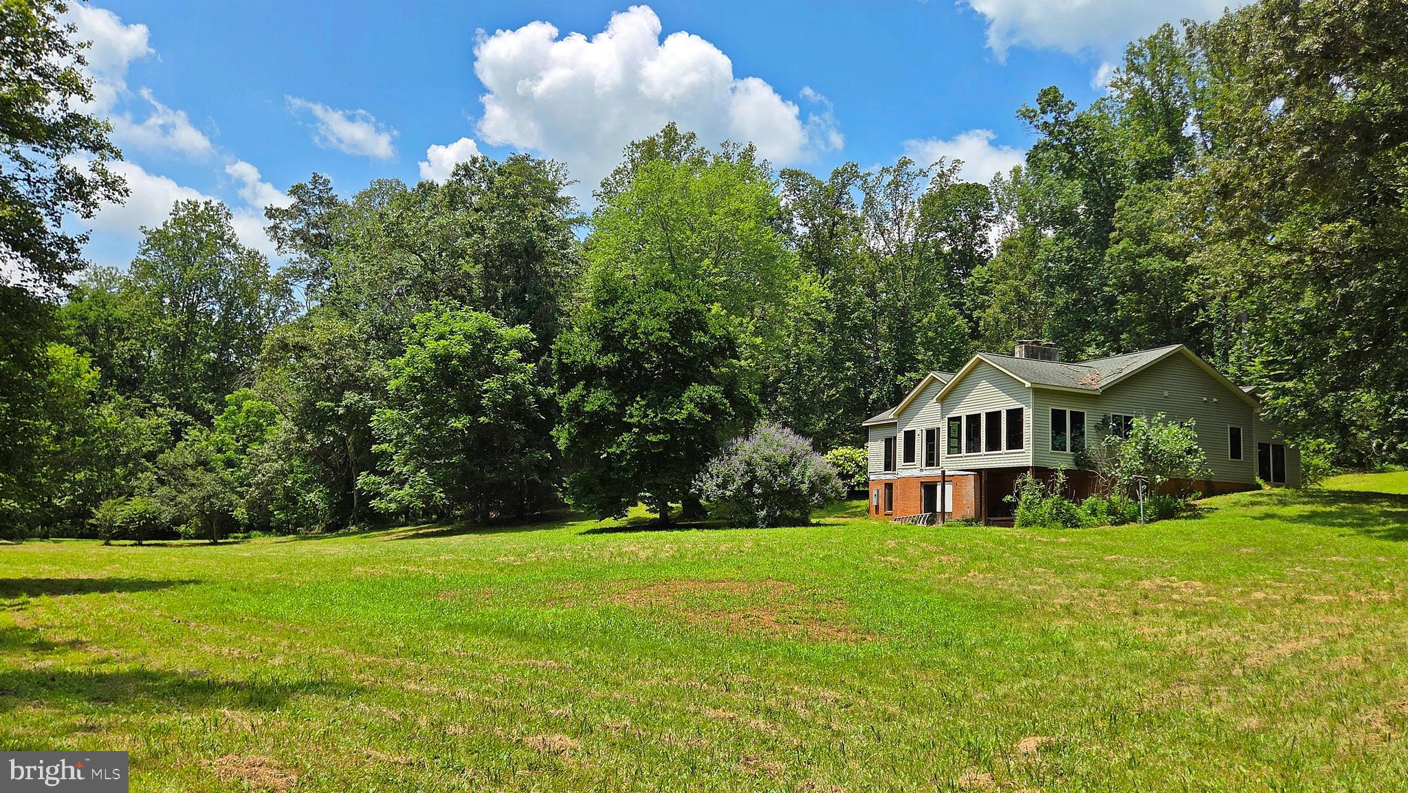 Bring your vision to life with this partially finished 5,000 SF Ranch style home nestled on a private and picturesque 10-acre oasis.  Approved Building Permits / Plans convey and are transferrable to the new owner. Offering the perfect canvas for customization. The existing structure offers a solid foundation with much of the heavy lifting already complete, including framing and major systems underway. Offering 5 generously sized bedroom suites, each with a private bathroom—ideal for comfort, privacy, and hosting. 4 of the bedrooms are located on the main level, making the layout perfect for families and guests alike. Soaring 9-foot ceilings and abundant natural light throughout the main house, every room feels open, airy, and welcoming. The stone for the facade and fireplaces has already been purchased and is awaiting installation. 2 inviting woodburning fireplaces with built-in blowers.  Radiant heated floors span the entire back of the house.  Walk-out basement opens to a tranquil yard bordered by a serene creek—your own peaceful oasis.  Oversized 1,250 sq ft garage offering ample space for vehicles, tools, and storage.  No HOA restrictions.  Convenient access to downtown Warrenton, commuter routes, local wineries, parks, and equestrian centers. Whether you're looking to finish and flip, rent, or settle in long-term, this is a one-of-a-kind opportunity to design and build exactly what you want—without starting from scratch.  Sold in as-is condition.