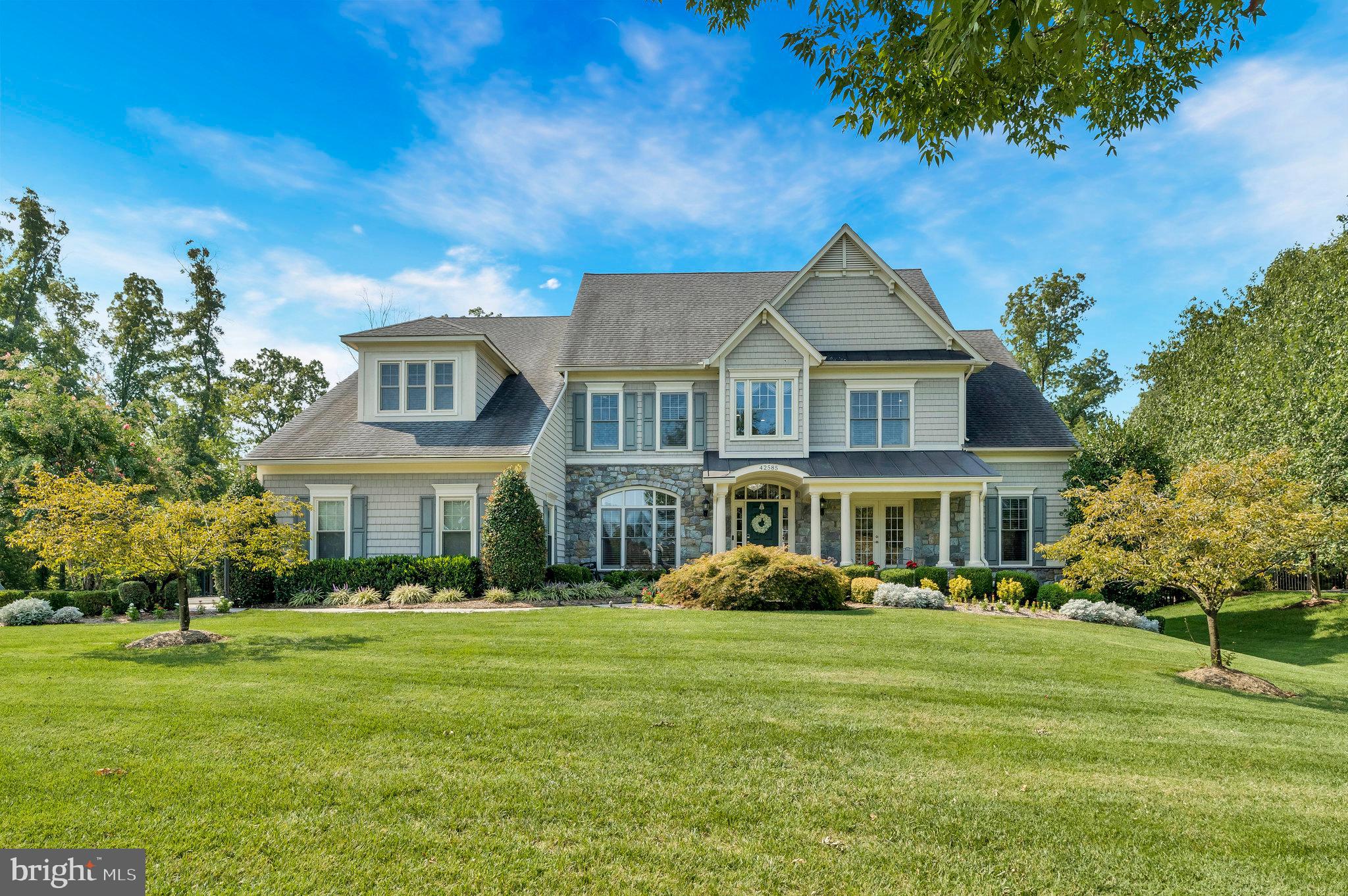 Welcome to your luxurious North-East facing oasis in a prime location! The inviting front porch leads you into a soaring two-story entry that sets the stage for this exceptional home. Enjoy your evening with beautiful landscape lighting. The main level features a spacious primary suite with a beautifully appointed bathroom and dual closets, providing the perfect retreat. A dual-roomed office with built-in shelves offers versatility and convenience, a gourmet kitchen with pull out drawers, complete with a grand island, is ideal for culinary enthusiasts. The family room, anchored by a cozy fireplace, opens to a large back deck that overlooks a serene, tree-lined backdrop. Home has an upgraded interior dimmer light package throughout. The elegance continues with a spiral staircase leading to the upper level, where you'll find a second primary bedroom with a large walk-in closet and an ensuite bathroom. The lower level is an entertainer’s dream, featuring your very own wine cellar, a pool table, and a custom-built expansive wet bar. This level also includes an additional bedroom and full bathroom, perfect for guests or extended stays. Situated on over half an acre, the flat backyard provides ample space for outdoor activities, while the spacious 3-car garage offers plenty of room for vehicles and storage. BONUS: the home comes with an irrigation system. Located close to the Ashburn Metro, Brambleton Town Center, and commutable roads for easy travel. This home is also just a short stroll from Beaverdam Reservoir, where you can enjoy a kayak boat launch, scenic trails, and more.

Accepting Back up Offers