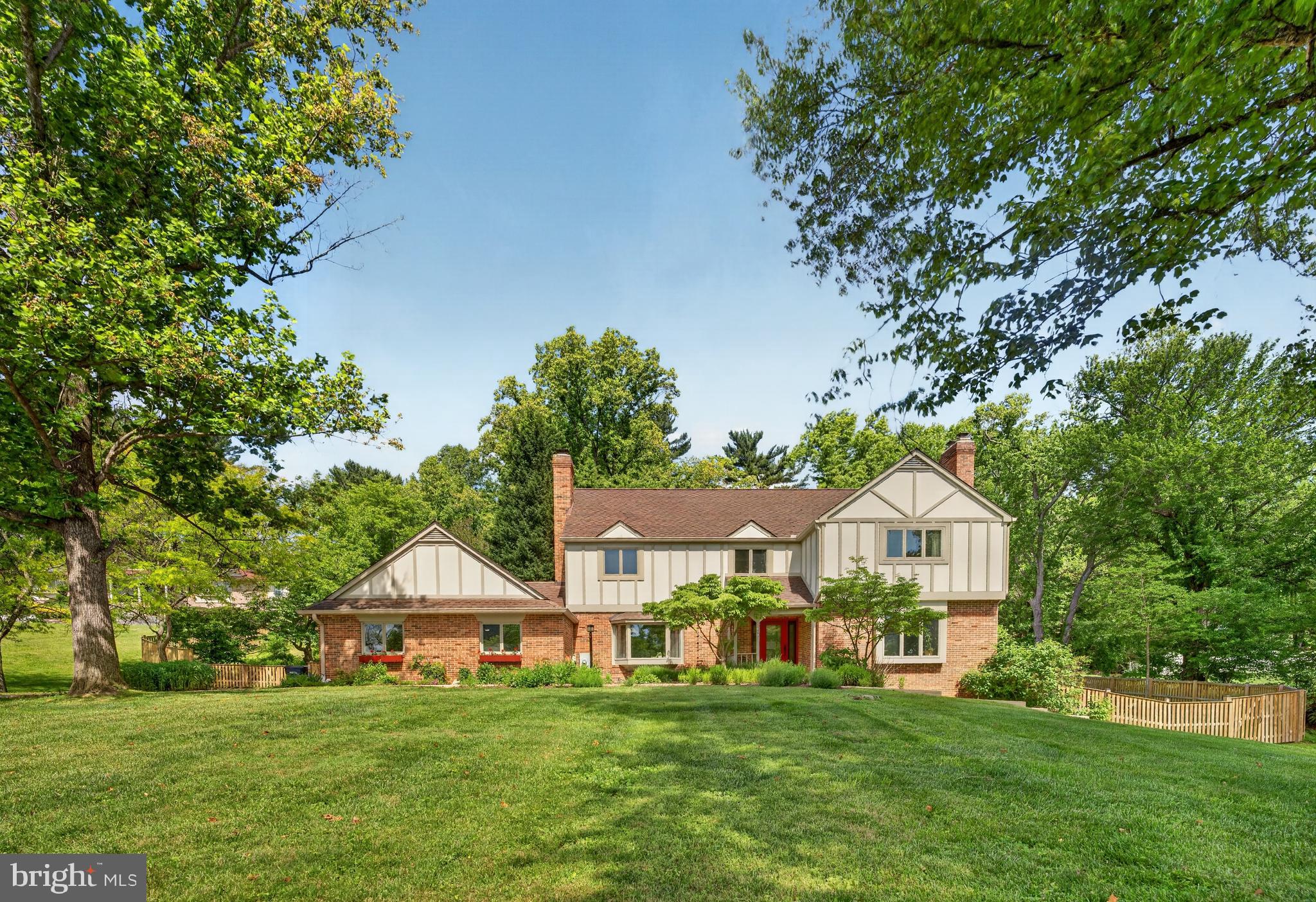 Open House 2-4 on Sunday 6/7!  Light-filled three-level Tudor home situated on a private 1.17-acre lot in the quiet Gayfields neighborhood. Thoughtfully updated throughout, this home features a semi-open floor plan, renovated kitchen, new windows and entry doors, upstairs laundry, a basement in-law suite, enhanced landscaping, and architectural upgrades.
Perfect for entertaining or cozy evenings by one of the home’s three fireplaces, the main level offers formal living and dining rooms, a beautiful family room with exposed wood beams and a bay window, a quiet corner office, and an exceptional kitchen designed to impress. The kitchen features two sinks, generous counter space, and a spacious pantry. A well-appointed mudroom off the kitchen provides access to the two-car garage, four additional parking spaces, and a secondary entry  door with double sidelights.
Upstairs are four generously sized bedrooms plus a fifth room currently configured as a convenient laundry room. The expansive primary suite includes a private hallway leading to an oversized bedroom and a large ensuite bath. Ample closet space can be found throughout the second floor.
The walkout lower level includes its own kitchen, living area, large tastefully updated bathroom,  private entrance, and patio. The space offers exceptional potential as an income-producing rental, in-law suite, guest quarters, or as a private retreat.
Outdoor living shines with a wide Trex deck overlooking a large patio and a concrete walkway that encircles the home. Certified as a Wildlife Habitat, the backyard is a true nature retreat featuring mature garden beds, a cedar privacy fence on three sides, and a see-through deer fence along the rear to preserve views of the wooded back lot.
Conveniently located just one mile from the Intercounty Connector with easy access to Washington, DC, Rockville, and Baltimore. Only 10 minutes to the Glenmont Metro and the shopping and dining destinations of Olney.