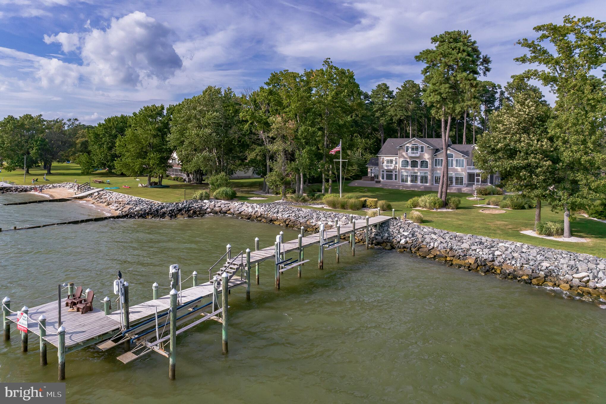 Stunning river front , costal design.  Gated residence on 2 very private acres. Main level offers gourmet kitchen, walk-in pantry, screened porch, custom-built bbq/cookout area & massive deck w/ hot tub, great room w/ coffered ceiling & fireplace, office w/ fireplace, 2-story entry foyer, formal dining area, media room! Spectacular westward views are a daily treat! Second floor features 4 bedrooms/3 full baths; one en-suite bedroom & the master suite privately situated at one end of the home with sauna, private laundry, soaking tub, private deck & sitting room w/ fireplace. The top (3rd) level of the home has a wonderful rec room or use as a 5th bedroom w/ built-ins, wet bar & a full bath.  Almost every room has incredible, Piney Point sunset views. Exterior of home has 2 sheds and detached 2 car garage (in addition to attached 2 car garage) with ample storage for all your outdoor activities.  Waterfront is riprapped, pier is almost new w/ 10,000 lb. boat lift and 2 jet ski lifts.