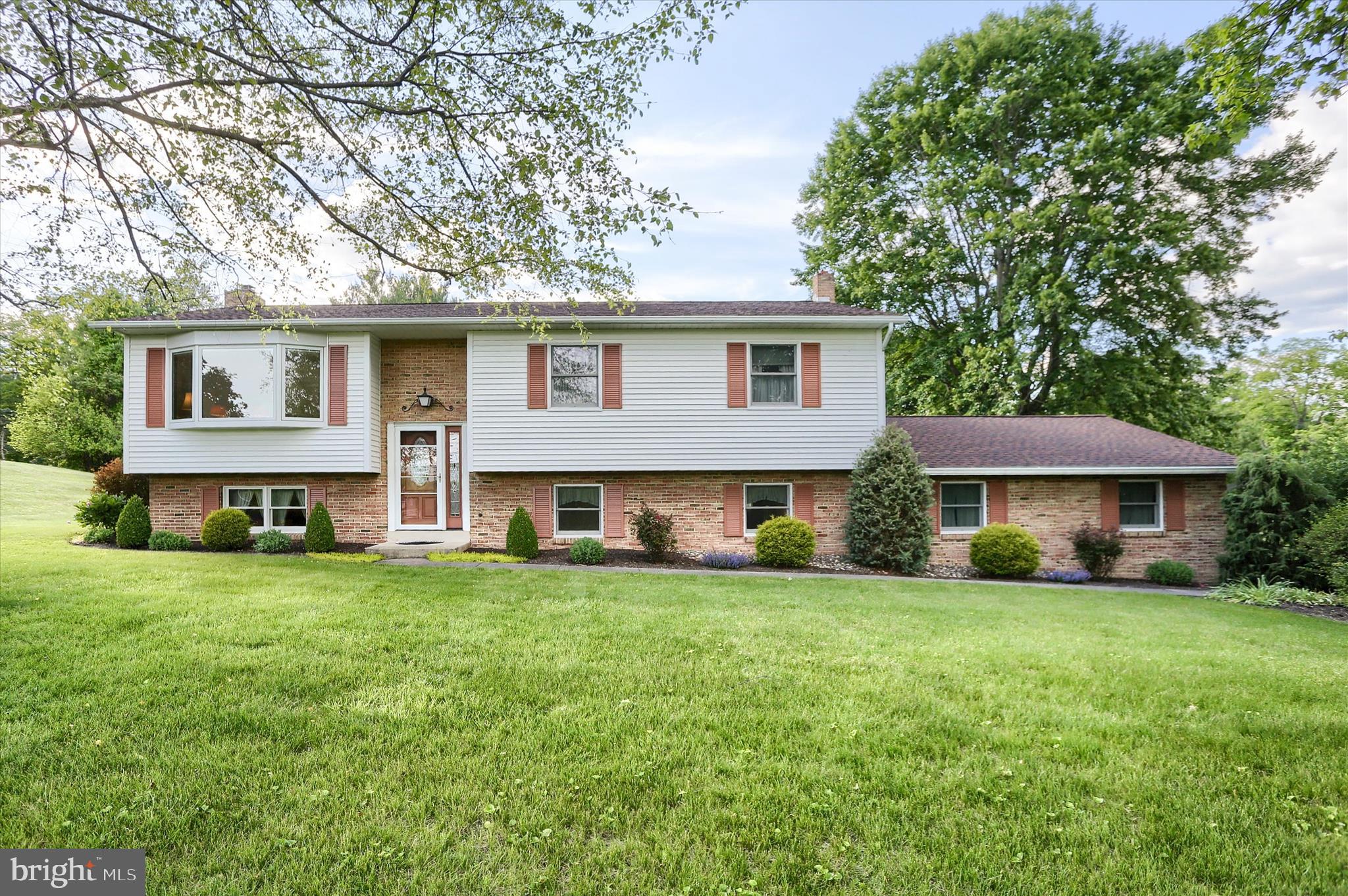 Nestled in the charming Pennwood community within walking distance to Juniata Elementary School, this delightful bi-level home offers a perfect blend of comfort and functionality. Built in 1975, this well-maintained original-owner residence boasts a spacious layout with four bedrooms and two and a half bathrooms. A large bay window in the living room fills the home with natural light and offers a beautiful view of the area, while the updated solid maple kitchen with Corian countertops has an amazing view of the backyard. Off the dining room, a large screened-in porch with awnings overlooks the quiet neighborhood. Three bedrooms and 2 bathrooms complete the top floor. The fully finished walkout basement provides additional living space, ideal for a recreation room and home office or fourth bedroom. The cozy family room is enhanced by a gas fireplace, creating a welcoming ambiance during cooler evenings. A convenient laundry chute from the top floor into the laundry room adds to the home's practicality, along with a half bath on the lower level. A mudroom leads to the attached 2-car garage. The exterior of the home is equally inviting, set on a generous 1.27-acre corner lot with beautifully landscaped front and back yards. Less than a mile from Rt 322, Juniata High School, and the Mifflin/Mifflintown Pedestrian Bridge, the location is within walking distance to the Juniata County Library, tennis courts, and a local park, yet the neighborhood is quiet and peaceful. The additional 1.19 acre lot in front will be offered to the buyer first at a price of $40,000. Please see attached list of home improvements including a new geothermal system in June of 2026. All kitchen appliances and washer/dryer convey with the house.