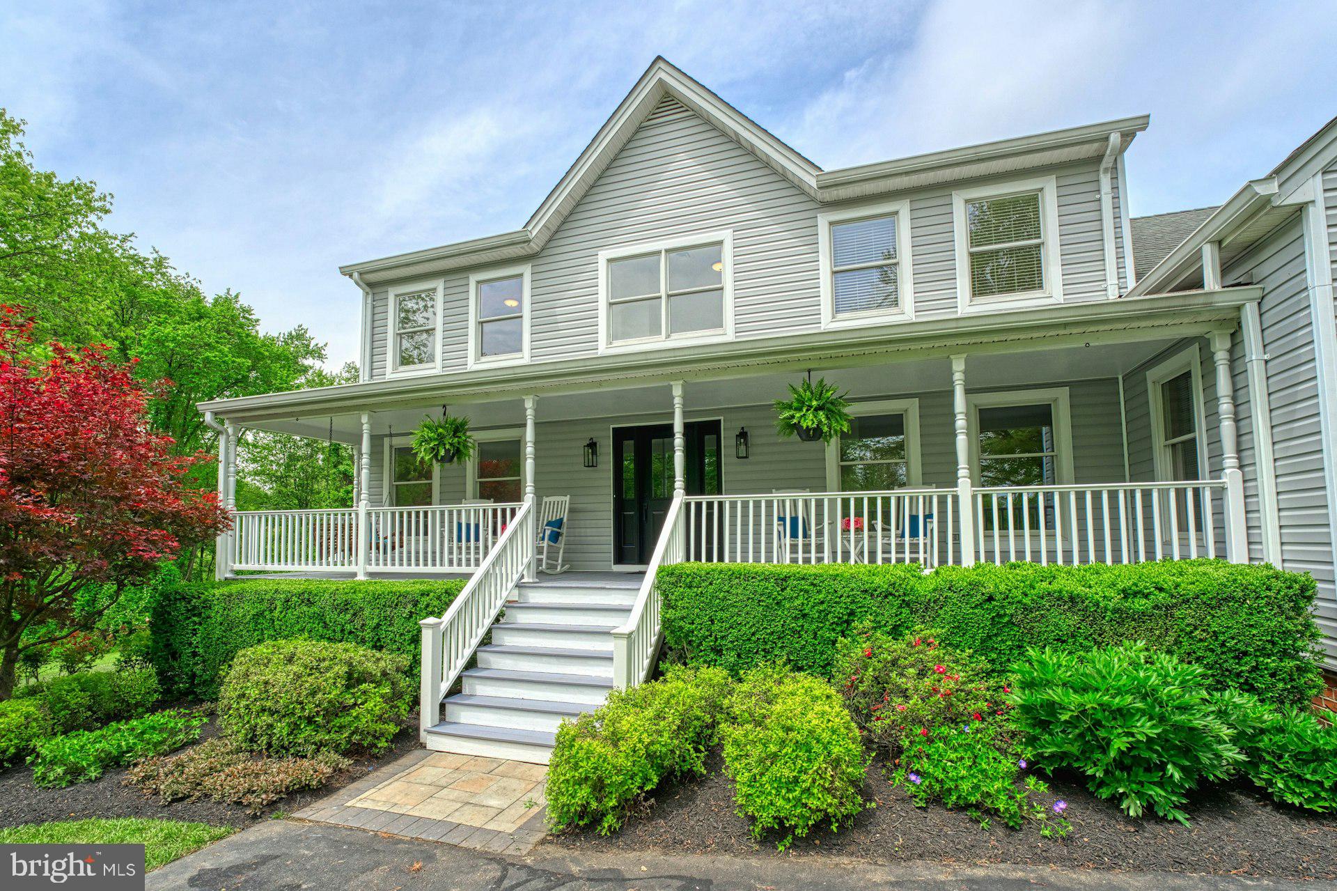 Stunning Renovated Home on 14 Serene Acres in Western Loudoun
Enjoy the perfect blend of privacy, convenience, and natural beauty in this fully renovated home situated on 14 peaceful acres—7 wooded and 7 open—abutting the W&OD Trail. Ideal for walking, biking, and exploring, this property offers a storybook setting with beautiful vistas, mature trees, and open fields, all just around the corner from Route 7, Leesburg, Purcellville, shopping, wineries, and everything Western Loudoun has to offer.
As you enter the property on the tree lined driveway you will be greeted by a new front door, inviting front porch, brand new siding, flowering mature trees and landscaping. The completely remodeled kitchen boasts custom soft close cabinetry, quartz countertops, stainless steel appliances, an induction stove, and expansive windows that showcase the stunning views. The open-concept main level also includes a dedicated study, formal living and dining rooms filled with natural light, and a two-story family room with a floor-to-ceiling brick fireplace, exposed beams and walls of windows overlooking the yard. The glass doors in the family room open to the covered custom deck with trex decking offering fabulous panoramic views, perfect for morning coffee or evening relaxation. A full bathroom is also located on the main level providing an option for a main level bedroom.
Upstairs offers five spacious bedrooms, a loft, brand new carpet and two fully renovated bathrooms. The primary suite includes a luxurious bathroom with a new double vanity, quartz countertops, custom tile, updated lighting, and a separate dressing area with custom counters, custom lighting and backlit mirror. The secondary bathroom has also been fully remodeled with high-end finishes.
The walk-out lower level includes a one-bedroom apartment with a kitchenette, den, private entrance, and separate living space—perfect for guests, rental income, or multigenerational living. The remaining basement area is expansive and ideal for storage or future finishing.  A large two story shed in the yard is spacious enough to park two tractors on the main level, with ample storage space above.  Whether you need a workshop, hobby space, or additional storage, this structure offers endless possibilities.

Outdoor living is a highlight of this property, with the custom covered trex deck off the family room, a fire pit, a salt water hot tub, and gorgeous mature landscaping. A charming babbling creek winds through the property, creating a peaceful setting for exploration and family fun. Whether you're entertaining or enjoying quiet evenings, this outdoor space offers the best of country living.  

Don't miss this rare opportunity to own a private retreat with modern updates and unmatched access to nature, amenities and convenience.