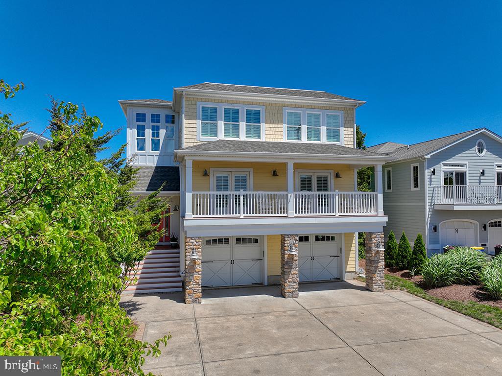 MAKE THE BEACH YOUR BACKYARD. Live in  sophisticated style, comfort, convenience and luxury - and all just steps to the sand and BAY VIEWS. Just imagine yourself relaxing & entertaining with friends and family on the multiple outdoor and indoor living spaces! This fully accessible 3 story home has elevator access to all floors. Looking for a solid investment? This property also has a well-established rental history that generates substantial annual rental  income of $150,000 on average.  Either way, this property comes FULLY FURNISHED - making your transition to beach living a breeze!
This exceptionally well-maintained home boasts a much desired open floor plan with hardwood flooring for relaxed living and gracious entertaining on the main level.  The well-appointed  gourmet kitchen features granite countertops, stainless steel appliances, & a huge breakfast bar and opens directly onto the spacious and inviting living and dining spaces. 
Those spaces lead you to a huge screened porch that overlooks the inground/deck PRIVATE POOL and BAY FRONT VIEWS OF LEWES BEACH - making this space perfect for everything from morning coffee to evening cocktails and glorious alfresco dining.  And all with picturesque sunrises and sunsets.  The expansive pool deck leads you to a large grass area perfect for kids and/or pets and a relaxing firepit area to add further to the entertainment value.  The main level also provides a large and welcoming primary bedroom with en suite bath, large closets and access to an outdoor deck, But it does not end there - the entertainment space continues on the ground level with a huge and inviting  family/game room with wet  bar, elevator,  and more.  On the third level there are three more spacious and dreamy bedrooms, one with an en suite bath, and an additional bath for the other two bedrooms.  The bedrooms have incredible views and additional access to deck space - all providing the perfect oasis for your family and guests.    The property boasts a 2-car garage and ample off street parking.  
This property truly has it all - with just steps to the bay & beach and a short walk or bike ride to the dining , entertainment & shopping of downtown Lewes.   Whether you use this property as your primary residence, a second home, or a profitable rental, this property is perfect for realizing your Lewes Beach dreams!